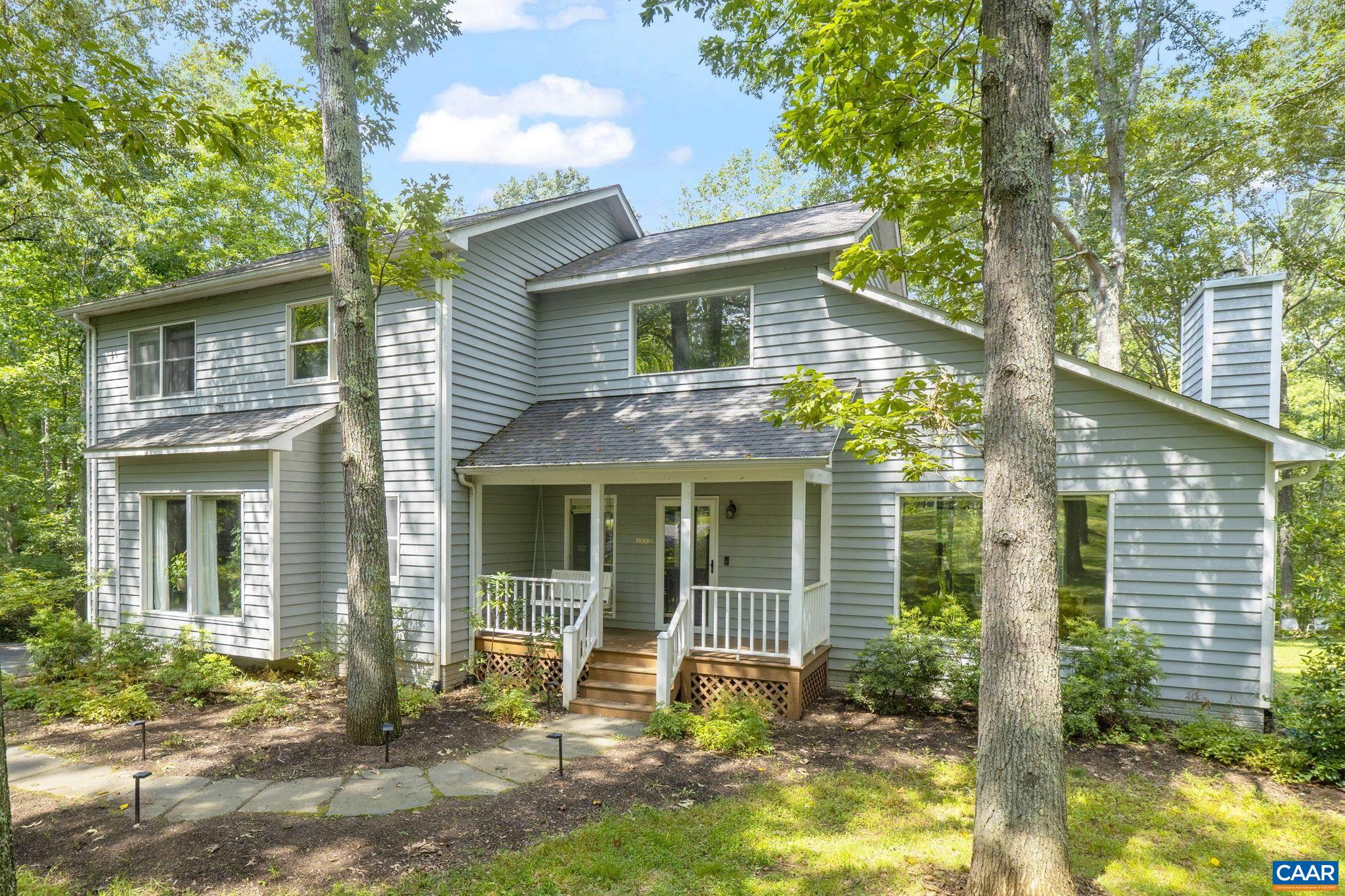 Enjoy serene country living in Advance Mills Village, Northern Albemarle County. This attractive 5 bedroom, 3 1/2  bath home is "one-with-nature" set in it's lush mature hardwood forest environment.   The spacious interiors of the home are well connected to nature too, courtesy of the large floor-up picture windows in the living room, primary suite, dining room & eat-in-kitchen. Morning light is found at the front covered porch w/ swing. The stylish layout of the main level has an open flow between the living, dining room & kitchen along with the spacious primary suite. The second floor includes a large loft area surrounded by 3 bedrooms and 1 full bath.  The walk-out terrace level includes the Fifth bedroom & full bath, plus it's own family room as well; perfect for guests or extended family.  The large rear deck has just been freshly stained and is ready for service.  On the patio below you'll find the new 4 person Outdoor Sauna which can be enjoyed year-round.