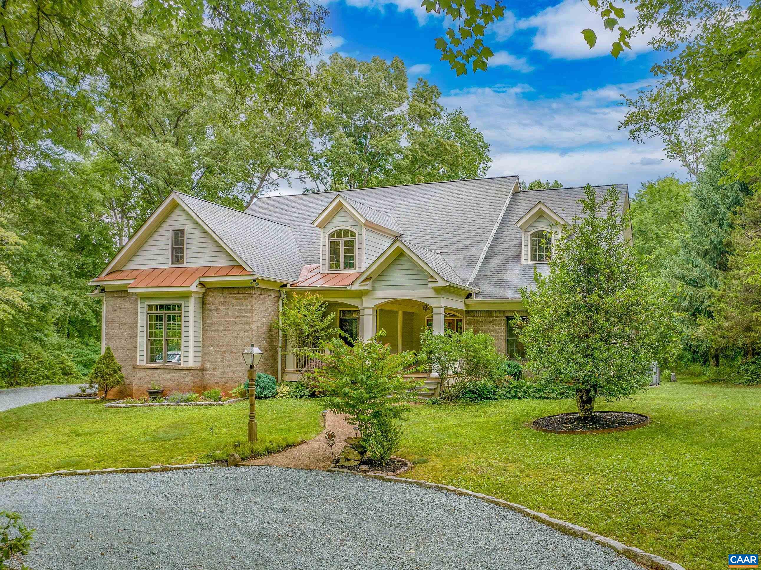 MULTI GENERATIONAL LIVING! Gorgeous ranch property on 7.5 acres in pristine condition & loaded with upgrades. Surrounded by wooded privacy, this property is situated way back off the road. Beautiful green grassy backyard w/raised garden beds & double decks (including a deck capable for a hot tub). Upgrades include; 9' ceiling height, wood windows & front door, solid hardwood floors thru-out (no carpet), crown molding, chair rail, bulters pantry & so much more. Gourmet kitchen features birch cabinets w/glass fronts, quartz counters, SS appliances, double wall ovens, beautiful tile backsplash, breakfast bar, built-in area for cookbooks & opens nicely to the breakfast room. A nice sized living room w/ vented gas fireplace (woodburning possible) opens nicely to generous sized foyer & formal dining room. Main level features 4 bedrooms all with en-suite bathrooms. Primary bedroom w/ walk-in closet, tray ceiling, double vanity, oversized walk-in shower tiled floor to ceiling. Main level laundry w/ birch cabinets & wash basin. The 2nd story features a built-in home office, 2 bonus rooms & 2 additional bedrooms both w/ en-suite bathrooms. FireFly & CenturyLink w/ high speed internet. 30 minutes to Cville & 10 minutes to Scottsville. Creek!