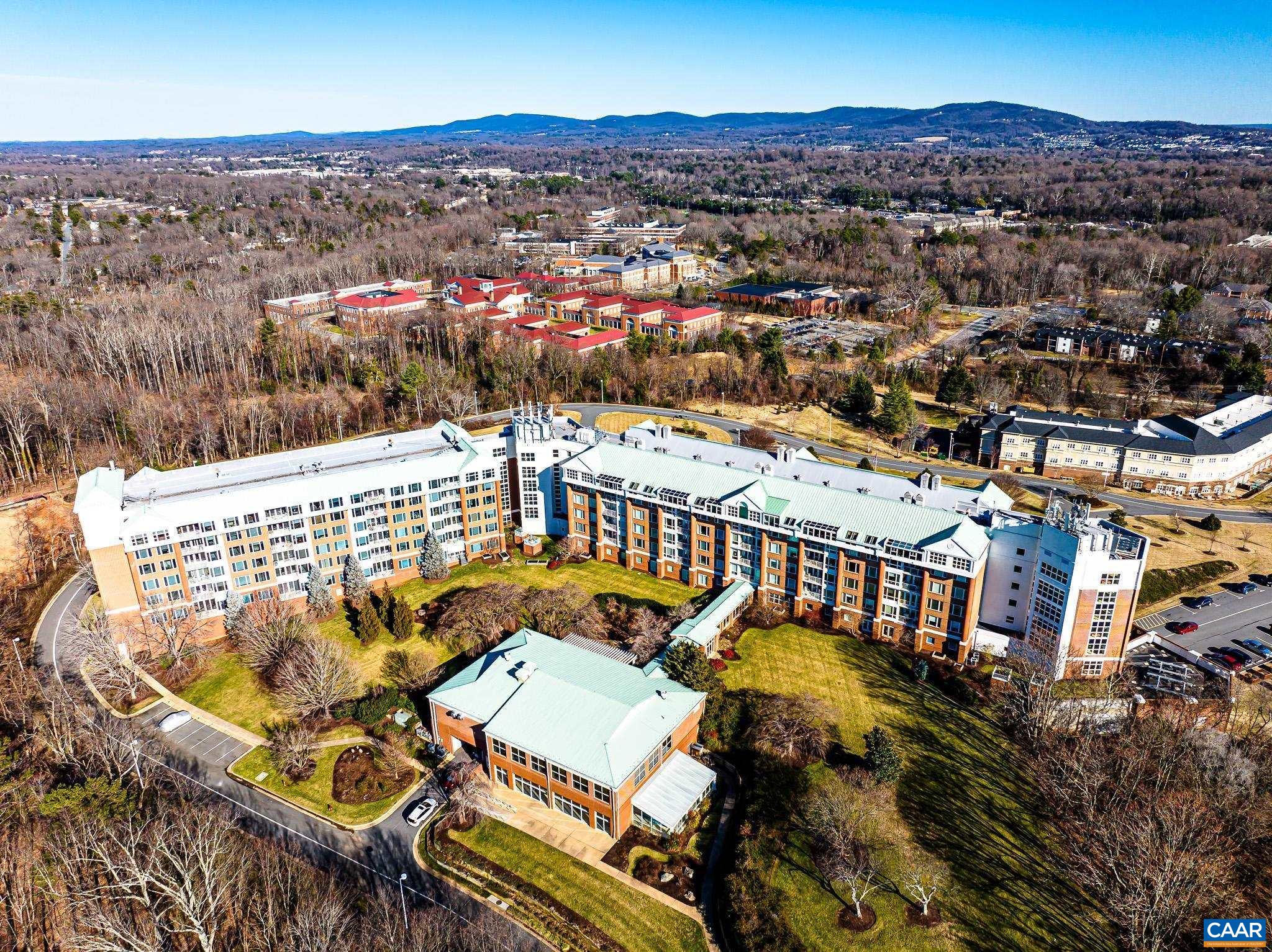 This adult community is waiting for you to call it home! This spacious 3 bedroom condo overlooks the western mountain views of Albemarle County. When you walk into your new home the walls of windows enhance the open living spaces with 9' ceilings and crown molding throughout. The living room opens to the balcony that overlooks the indoor pool. The dining room with chair railings leads to the galley kitchen with all appliances and a pantry with pull out shelving. The primary bedroom includes a walk in closet and ensuite bath with a double bowl vanity, walk in shower and jacuzzi tub. The adjoining walk in closet leads you to another bedroom that can also be used as a den with access to the balcony. The third bedroom, full bath, laundry room with washer and dryer, and plenty of storage spaces complete the layout of your new home. Amazing amenities for an easy lifestyle include: Three dining rooms, coffee lounge with daily newspaper services, library, art studio, hair salon, state of the art fitness center, 75’ heated pool with hot tub, indoor game room with billiard and ping pong tables, outdoor terraces, bocce, corn hole, croquet, walking trails, raised bed for gardeners, meeting rooms and atriums throughout.