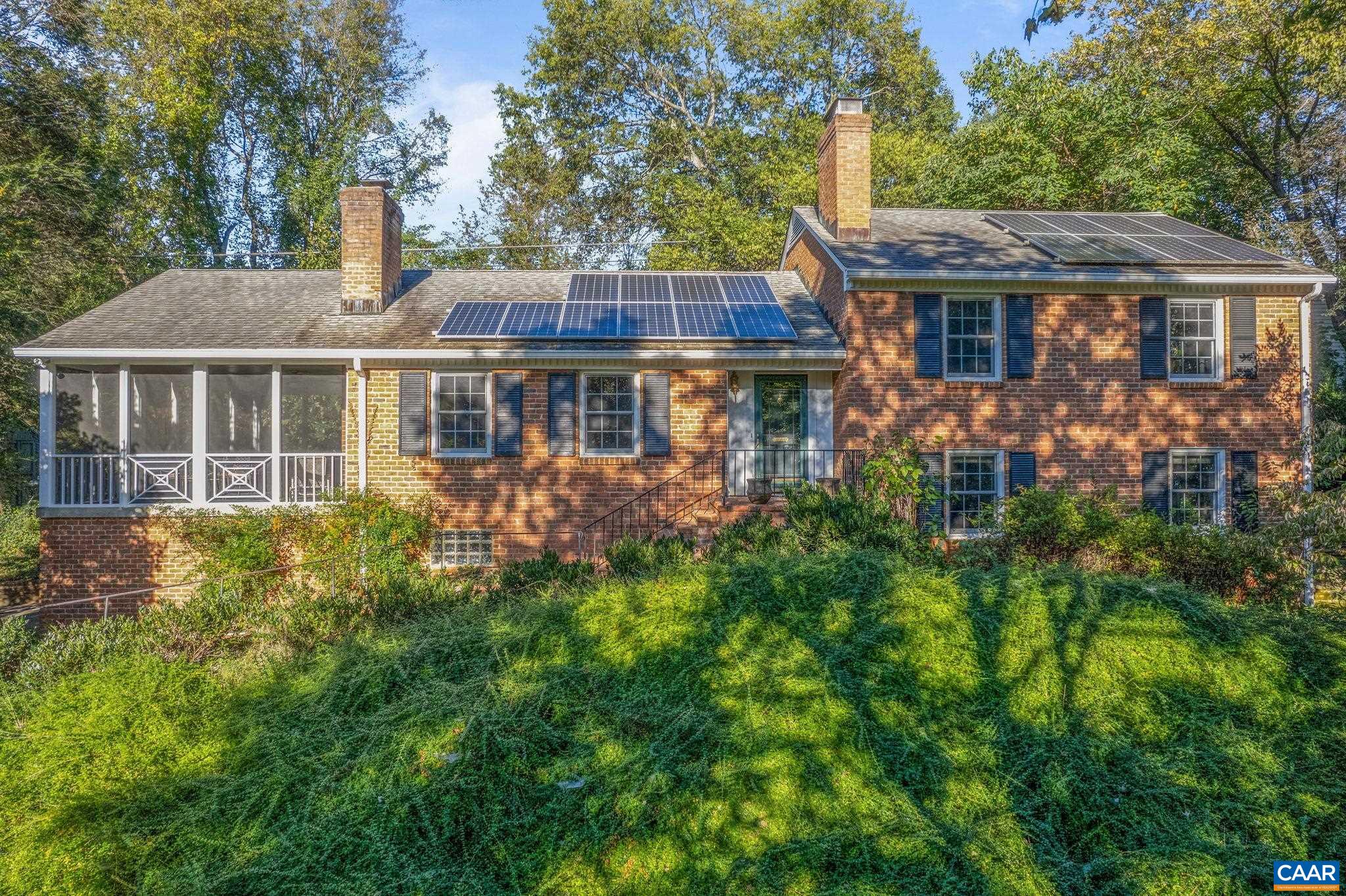 This handsome brick home sits on a coveted location in the community of Bellair, backing to the beautiful Birdwood Golf Course, protected from road noise yet it's easy to access the Rt 29/250 Bypass and get to wherever you need to go--north, south, east, or west. An 8.7 kW Solar System produces enough power that between net metering and the sale of energy credits, the cost of electricity for this home approaches zero. The primary bedroom suite includes a large attached bath, a walk-in closet, and separate cedar closet. The kitchen has glass front maple cabinetry, stainless appliances, and custom concrete counters. Enjoy entertaining on the spacious (450 sqft) screened porch just off the Dining Room. Beautiful hardwood floors on upper levels and New Zealand wool carpet on lower levels, thermal windows and doors and 2 wood burning fireplaces--one with wood stove insert. Access the hiking trails at Foxhaven Farm from the end of Canterbury Rd only a few blocks away or walk to the nearby community pond. Watch the sunset over the mountains from the edge of the golf course. Large 1+ acre lot has lots of space for gardening and games. Paved driveway has extra parking spaces for guests. Plenty of storage in a walk-up attic & the garage.