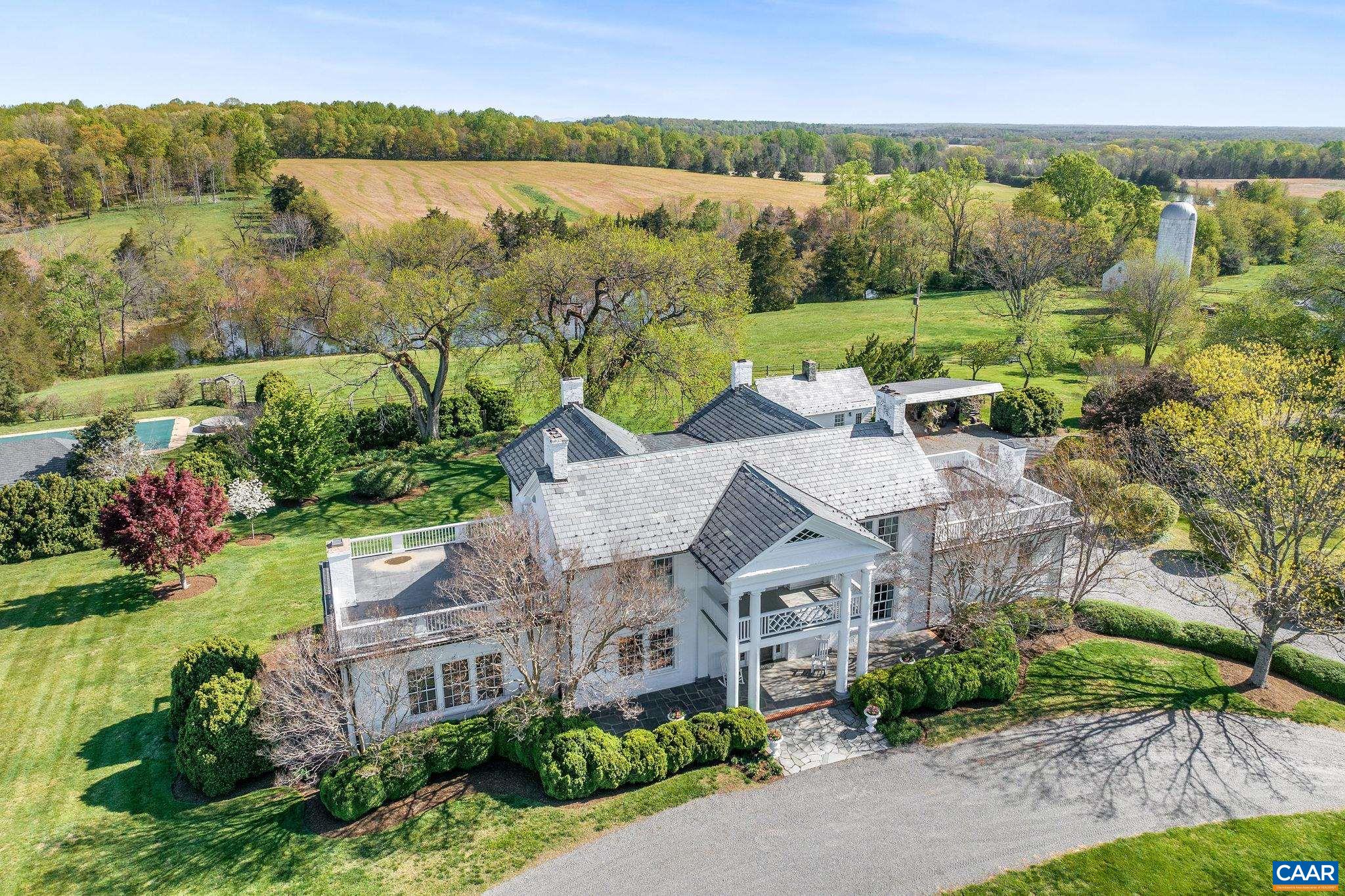 Set in the heart of bucolic Southern Albemarle amidst other noted properties, c. 1790 Liberty Corner offers a statement Virginia estate.  At the heart of this manicured, 500 acre farm and set in absolute tranquility, is an historic residence in flawless condition that melds period charm with modern amenities.  Improved by 3 guest houses, pool, pool house and gardens, the home enjoys stunning, panoramic views of the rolling Virginia countryside and two large lakes.  A third, charming guest house aka 'The Lodge' looks over a third lake on the property.  Pristine farm improvements include an equestrian facility with indoor and outdoor arenas and 26 stalls, kennels complete with an office and trophy display room, two large hay barns that could be converted to dramatic event structures and 3 tenant or rental cottages ideal for staff or income. Rarely does such an incredibly well maintained, historic estate property reach the marketplace.  Truly, no stone has been left unturned by the owners in their careful stewardship of Liberty Corner. With multiple division rights, the property offers a significant Conservation Easement opportunity.  Significant additional acreage available.  25 minutes to Charlottesville.