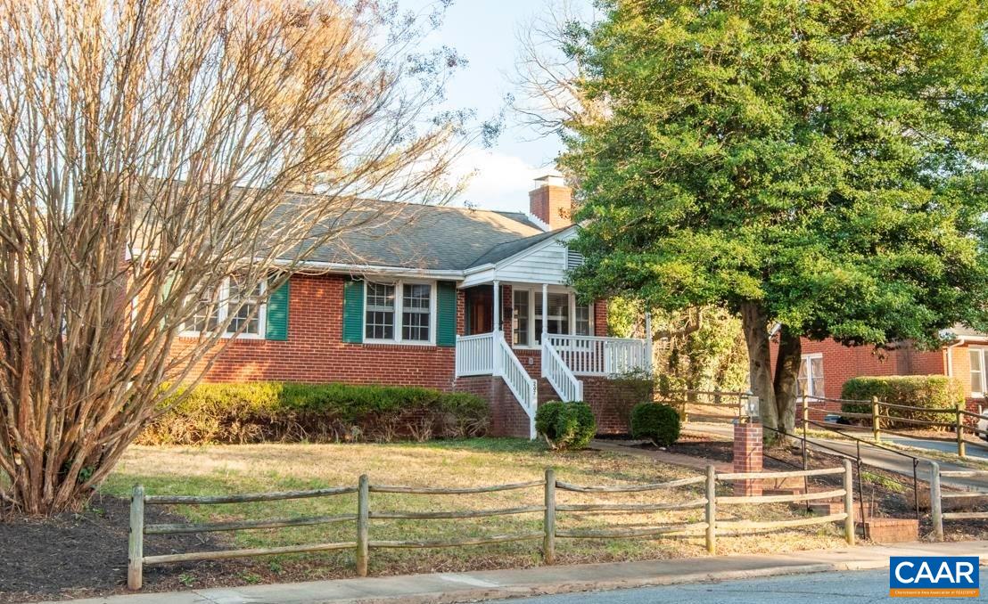 Charming brick cape cod located in the heart of Fry's Spring with enclosed sunroom and walkout basement. Step inside from a covered front porch to a bright living room with wood burning fireplace. Genuine hardwood floors stretch throughout the main level. Kitchen and dining area open a large sunroom with character-rich brick floor and three walls of windows. Use this space to entertain or enjoy as a home office or gym space. Full tile bath with pedestal sink upstairs and half bath downstairs. A staircase inside the home leads to the finished walkout basement with kitchen. Or, access the lower level by a separate entrance that leads to the backyard. Dine outdoors on the newly designed and installed paver patio. Grow your flowers, fruits or veggies in the raised garden beds. Vibrant fuscia blooms burst from the mature crape myrtle in the front yard.  Stroll to Azalea Park, pool, restaurants, coffee and UVA sports. Located on the City bus line and an easy commute to UVA/hospital. Gas water heater (2021). Tilt sash windows (2018). Roof (2015)