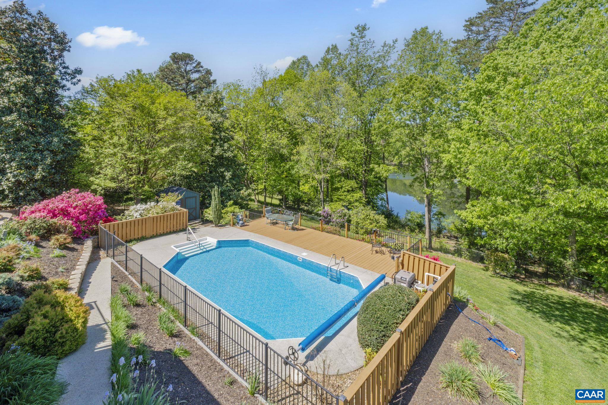 This well-maintained lakefront property offers you the ability to structure your living accommodations to fit your needs.  Whether you have a large household that requires 4 bedrooms, a multi-generational arrangement requiring two separate living spaces, a need for two separate home offices, including one with an outside entrance, or a wish to rent out part of your home as a 30 day plus rental to supplement your income, your solution is here.  Close to shopping and dining, less than 6 miles to the Ting Pavilion, you will find this relaxing refuge with not only a lake, but your own private heated inground pool.  Watch the sun set over the lake as you sip your favorite beverage on the screened in porch or unwind after a hard day's work by casting for bass from your backyard.  Watch the stars above as you float on your back in your secluded pool.  You owe it to yourself and your loved ones to consider this opportunity for a staycation worthy residence.  Come see the possibilities.