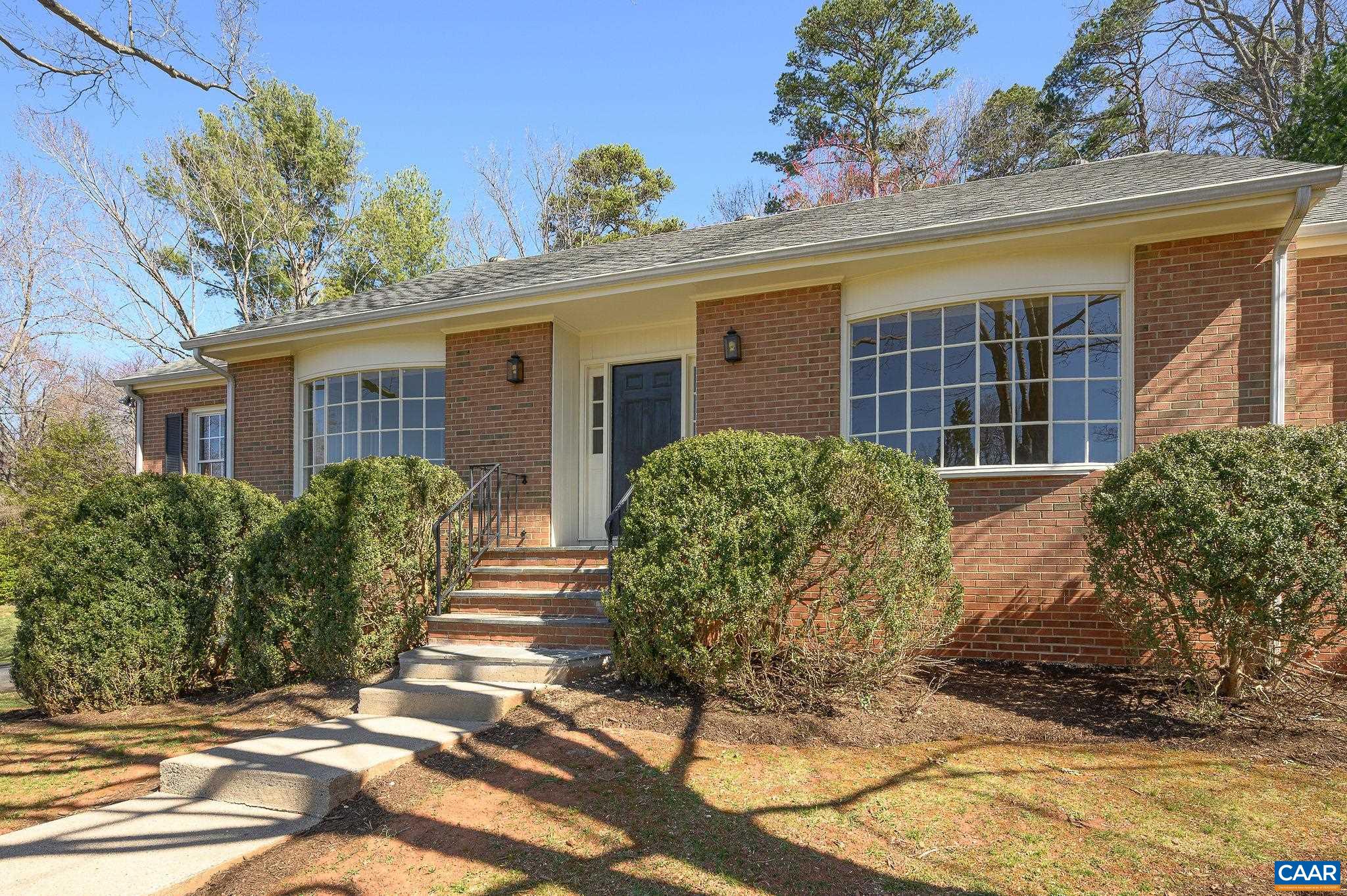 This classically styled brick ranch in the Ivy Elementary district has been loved by the same family for 35+ years & is all you could want in a home. A south-facing sunny, deep front lawn welcomes you to a lush property dotted with mature trees & plantings. The face of the home has wonderful symmetry: note the front door flanked by two wide, tall divided-light bay windows. The main level of the home features solid oak floors, which are in great condition, 6 panel wood doors & a wood burning fireplace. The formal living room faces front to the sun, while the family room opens to a deck overlooking light dappled woods for excellent privacy. This level of the home has 3 bedrooms & 2 full baths. The large finished basement offers a "rec room" (with 2nd fireplace), a large bedroom & a half bath. Exit directly to the oversized 2 car garage. This home is very well maintained. The kitchen, bathrooms & basement are awaiting the new owner's vision for updates & the home is priced to allow you to make your personal decorative mark on it! Close to the sought-after Ivy Elementary, just 5 miles west of UVA and all Charlottesville offers, this home is also convenient to Crozet, Vineyards, the Blue Ridge Mountains and recreation of all sorts.