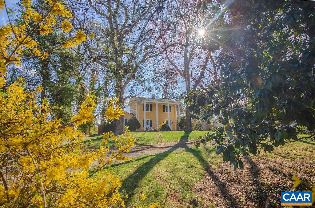 Step into history with this beautifully updated, light-filled 1800s farmhouse, once the original homestead that later became this charming neighborhood. Featuring 3 bedrooms and 2 full baths, this home is nestled on a private, landscaped lot with lush gardens, mature trees, and a certified wildlife habitat, creating a peaceful retreat. Outdoor living shines with a stone patio, a spacious front porch, and a rear deck—perfect for unwinding with a glass of wine. Inside, extensive renovations blend modern comfort with timeless character. Large windows flood the space with natural light, showcasing original architectural details alongside beautifully updated finishes. A rare opportunity to own a piece of history while enjoying modern conveniences—this one-of-a-kind home offers privacy, charm, and natural beauty in an unforgettable setting!