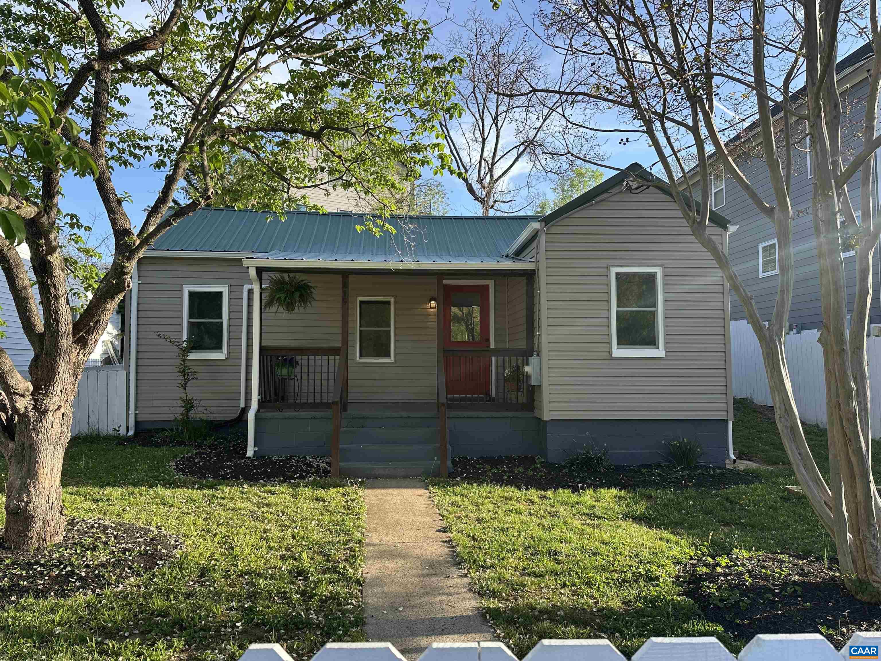 New Price! This darling Belmont cottage packs a punch! You will adore the white picket fence the surrounding the front yard, and the covered porch where you'll enjoy the view of Carter Mountain and watch baseball games right across the street at Quarry Park. The new metal roof adds to the charming exterior style and vintage flair.  Inside, the home has been completely renovated and features modern conveniences throughout.  New white shaker cabinets are found in the kitchen plus sleek stainless appliances, and a large tiled shower in the bathroom. Ductless HVAC system was added for heating and cooling. There’s even a spacious mudroom off the back with a sliding barn door. At 850 square feet, it's cozy but smartly laid out with 2 bedrooms plus an office. Just 1 mile to the Downtown Mall, minutes to UVA, and around the corner from I64, it's a great location! If you're looking for an affordable, low-maintenance, move-in ready home in a fantastic location, this one's got the charm and the updates to match. Don't miss this opportunity to see this one before its gone!