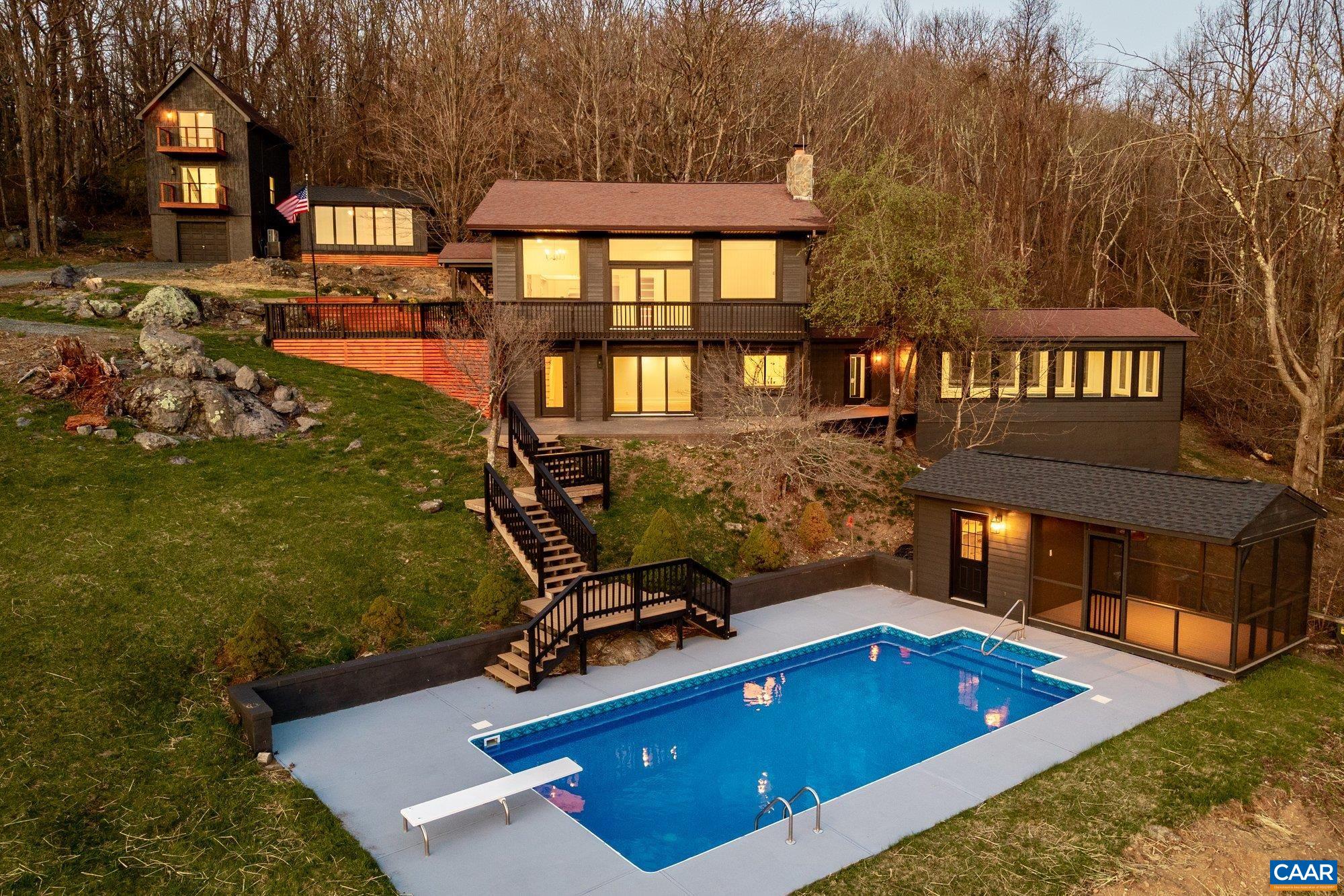 Million-dollar views for under a million.  Perched at nearly 3,000 feet on the most private lot on Flattop Mountain, this fully renovated retreat offers sweeping views, total seclusion, and direct access to the Appalachian Trail just 380 feet away. It’s the largest private residence on the mountain and the only one with two pools—a year-round indoor endless lap pool and a refreshed heated outdoor pool with new decking, liner, and outdoor shower. The main house has soaring ceilings, a stone fireplace, hardwood floors, wraparound deck, and brand-new everything: HVAC, plumbing, electrical, windows, doors, kitchen with quartz countertops and 48” gas range, and a luxe master suite with soaking tub and private patio. Also includes a 3-level guest house with balconies and full kitchen, a separate mountain-view office, 125” projector screen, high-speed fiber internet, and whole-house backup generator. Bordered on three sides by Shenandoah National Park with no visible neighbors, this is the ultimate short-term rental, second home, or full-time mountain getaway—with unmatched AirBNB potential and minimal local restrictions.