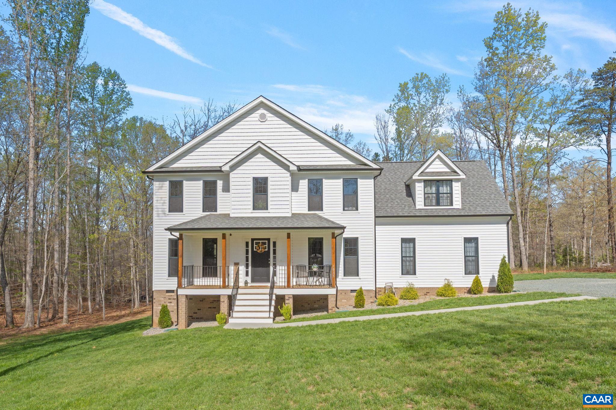 Experience the charm and modern comfort in this almost-new 5-bed, 3.5-bath home in a peaceful, wooded setting of almost 5.5 acres. The 2700 square foot layout is thoughtfully designed for everyday living and entertaining. The heart of the home is the spacious open kitchen and dining area, boasting a large island, ample pantry space, and elegant finishes. Dual primary suites, one on the main level, offer flexibility for multi-generational living or a private guest retreat. Upstairs features generously sized bedrooms and a convenient second-floor laundry room. The expansive, mostly level yard offers endless potential to enjoy the outdoors. The full-length front porch provides classic curb appeal. This home blends style, space, and serenity—all just minutes from modern conveniences.