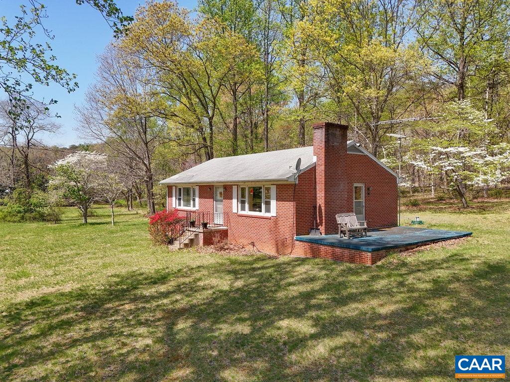 Private 40 ACRE property with a solid brick ranch style home in Crozet/Albemarle County with beautiful mountain views.  The home and land have been in the same family for many years.  House is well built and has great potential to expand and/or update.  The property also has a large 3 car detached garage/workshop that is nearly 1500 square feet. The garage has a wood burning stove as a heat source. The garage/workshop is all block construction with great storage as well.  Hardwood floors throughout the home with New roof on the house and garage. Home also has a wood burning stove. Much of the value is in the 40 acre parcel that is very private with trails, stream with fish, and a spring.  Home has a whole house generator!  Property backs to the Shenandoah National Park and is within minutes of a wonderful state park, Patricia Ann Byron Forest Preserve. Enjoy hiking, camping, horseback riding, and fishing in this beautiful area of Albemarle County.  Lots of hardwood trees with rare American Chestnuts, Oaks, and Black Walnut trees.  Come see all the Wildlife this property has to offer! The home is located in a desirable school district.  A great value for 40 acres in sought after Albemarle County!