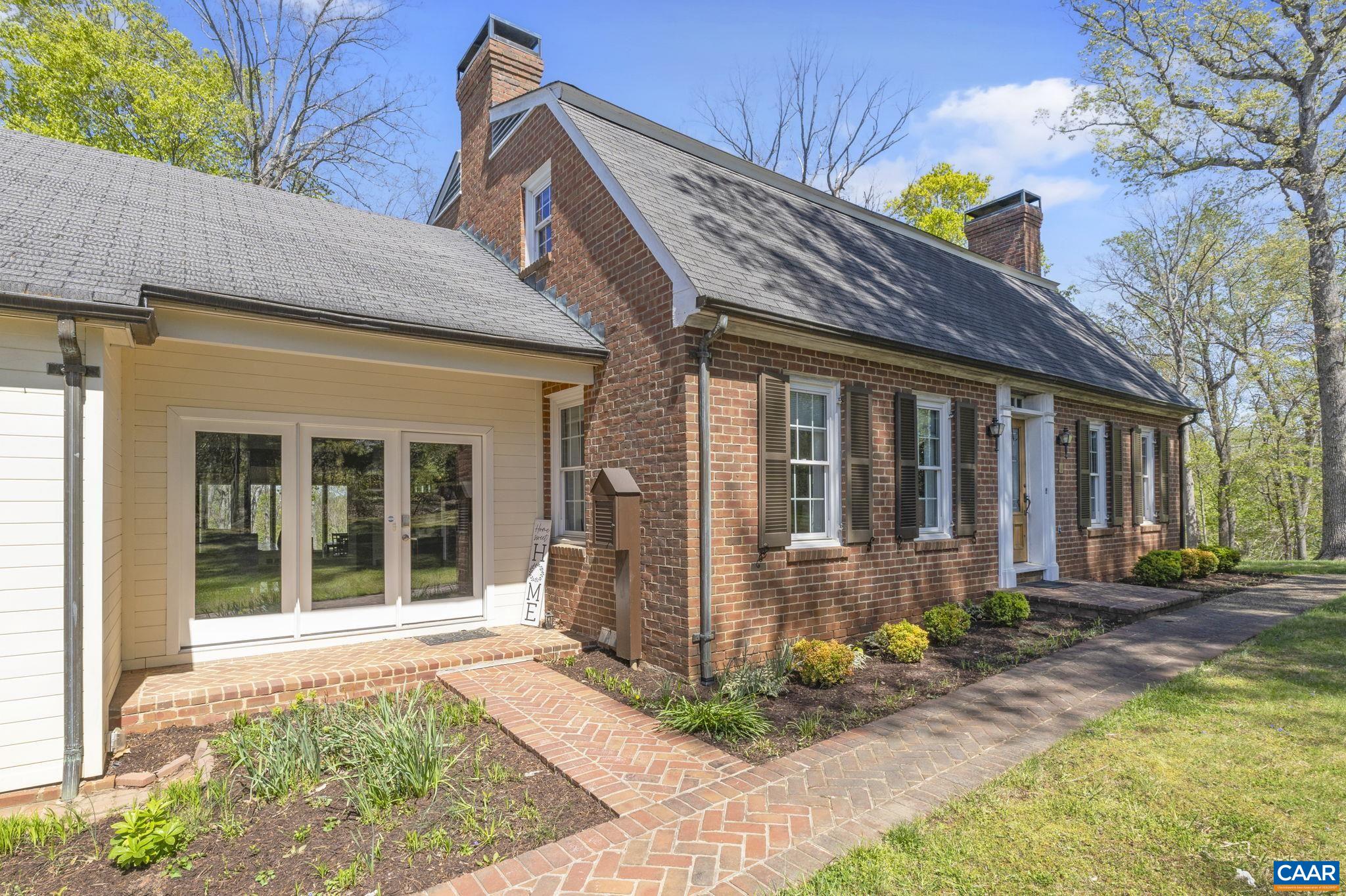 The most remarkable of finds! Nearly 12 acres of lakefront property offering a stately 5 bedroom, 3.5 bath home with terrace level apartment and situated in the centrally located Carrsbrook neighborhood. Restored, improved and tastefully updated, Fairgrove features a well appointed kitchen with tile backsplash, granite counters and a large island. Just steps away is the dining area with brick floor, fireplace and dramatic natural lighting. The lake-facing sunroom literally shines with three walls of glass, hardwood floors, vaulted ceilings and exposed beams. Included on the entry level, a gracious foyer which opens to traditional family and living rooms, a half bath, home office, mudroom and laundry as well as access to an attached garage. Upstairs are three additional bedrooms including the Primary bed and bath with fireplace as well as a full hall bath. The terrace level apartment features two additional bedrooms, a full kitchen and bath and generous living room with brick fireplace and has both an interior and private exterior entrance. Behind the home and accessed by a separate drive is an additional 3 bay garage and an open face barn and all of this perched above the woods and lake beyond.