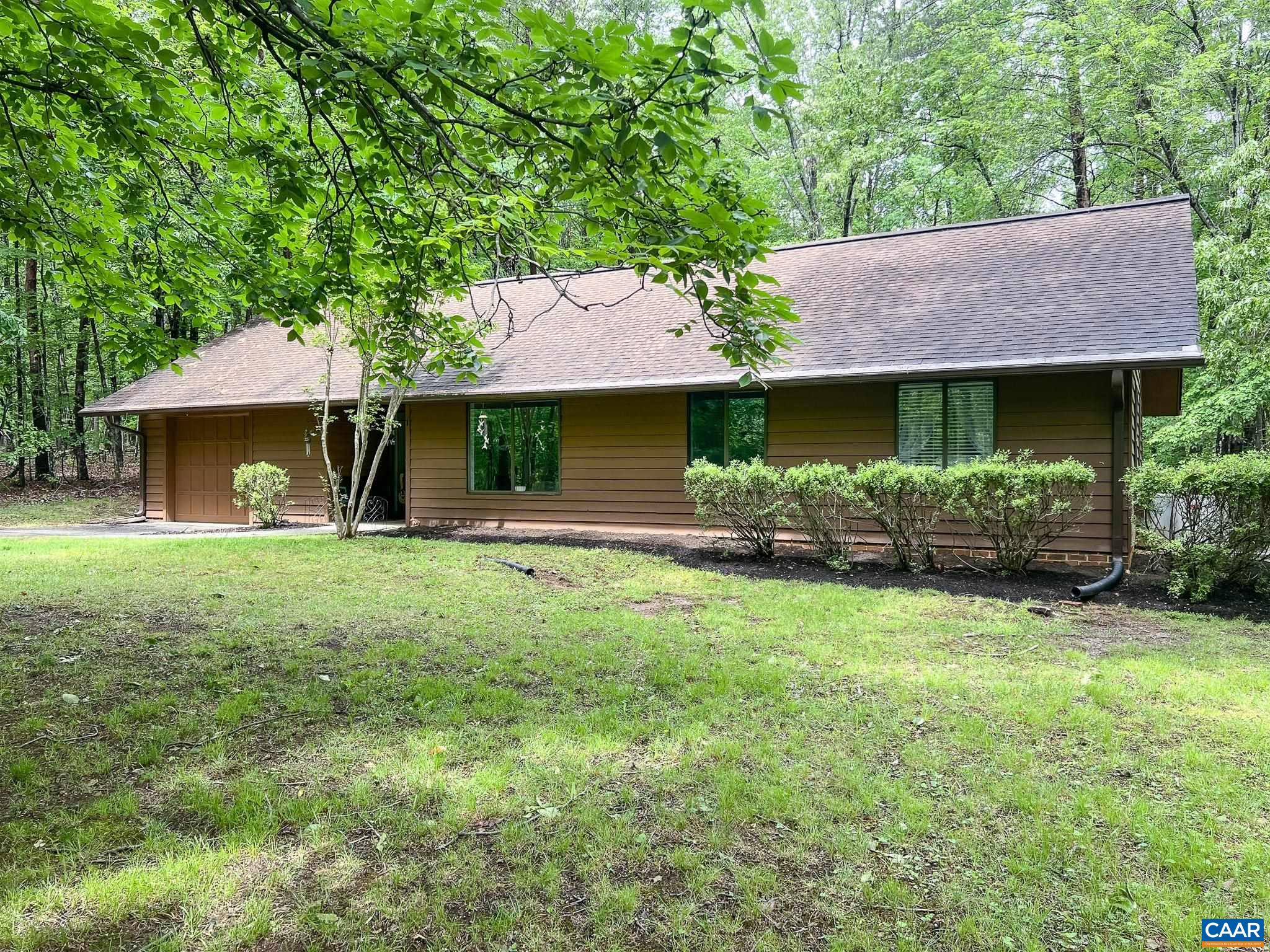 Nestled on a private, partially wooded lot at the end of a quiet cul-de-sac, this beautifully renovated ranch home offers comfort, convenience, and modern updates throughout. Fully remodeled just four years ago, the home features a stunning kitchen complete with new cabinetry, stainless steel appliances, and granite countertops. Fresh, neutral paint inside and out, along with durable LVP flooring throughout, creates a cohesive and stylish feel. The hall bathroom has been tastefully updated with a new vanity and a tile shower surround, while the primary suite boasts a thoughtfully designed ADA-compliant bathroom, featuring a wide doorway with sliding barn doors and a spacious roll-in shower.  Enjoy a nearly level lot with a grassy front yard and a fenced patio area in the back that opens to peaceful, wooded views—perfect for relaxing or entertaining. The oversized one-car garage offers ample space for both parking and storage, and the laundry room includes floor-to-ceiling cabinetry for additional organization. Major system updates include a new HVAC system (2020), updated electrical panel and outlets, and a second layer of roof shingles added within the past 10 years, offering peace of mind for years to come. Truly move-in ready!