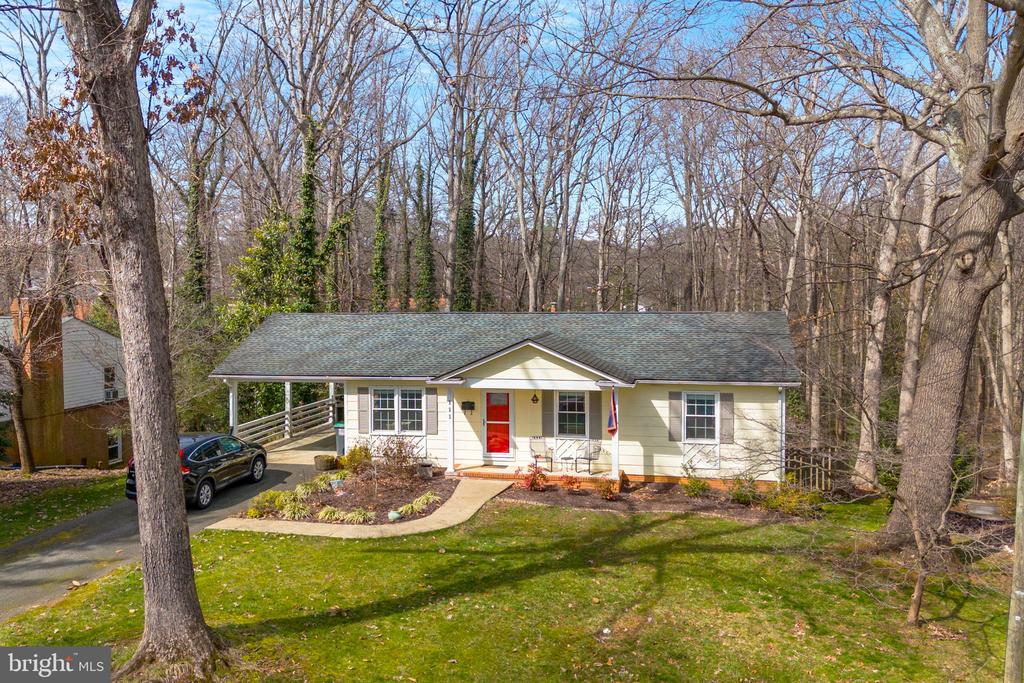 If your priorities in a new home include being located in an established, quiet, walkable neighborhood near schools in central Charlottesville - don't miss this charming, updated 3 bedroom, 3 bath home with finished walk-out basement over 2000 sf. total on a cul-de-sac in Johnson Village! The last major renovation in 2013 included a new kitchen with dovetailed drawers, black granite countertops, gas cooking, eco-friendly bamboo floors, new double-hung windows throughout the house, premium LVP floors in the large downstairs family/play room, radon mitigation, updated hall bath and a new ensuite bath with hex-tile floors, ceramic tile shower, double vanity and separate walk-in and reach-in closets in the generously sized primary bedroom. More recent upgrades include a new air handler in 2016, and newer refrigerator , microwave, stacking washer/dryer, Wifi-enabled lighting and SimpliSafe security system. Plentiful storage includes a utility/workroom with metal shelving, pegboard wall and chest freezer. Enjoy outdoor living under your covered front porch as well as your carport which doubles as a sheltered patio/grilling space. Doggies will enjoy the fenced yard within the .39 acre lot - and you'll find calm from the natural landscape