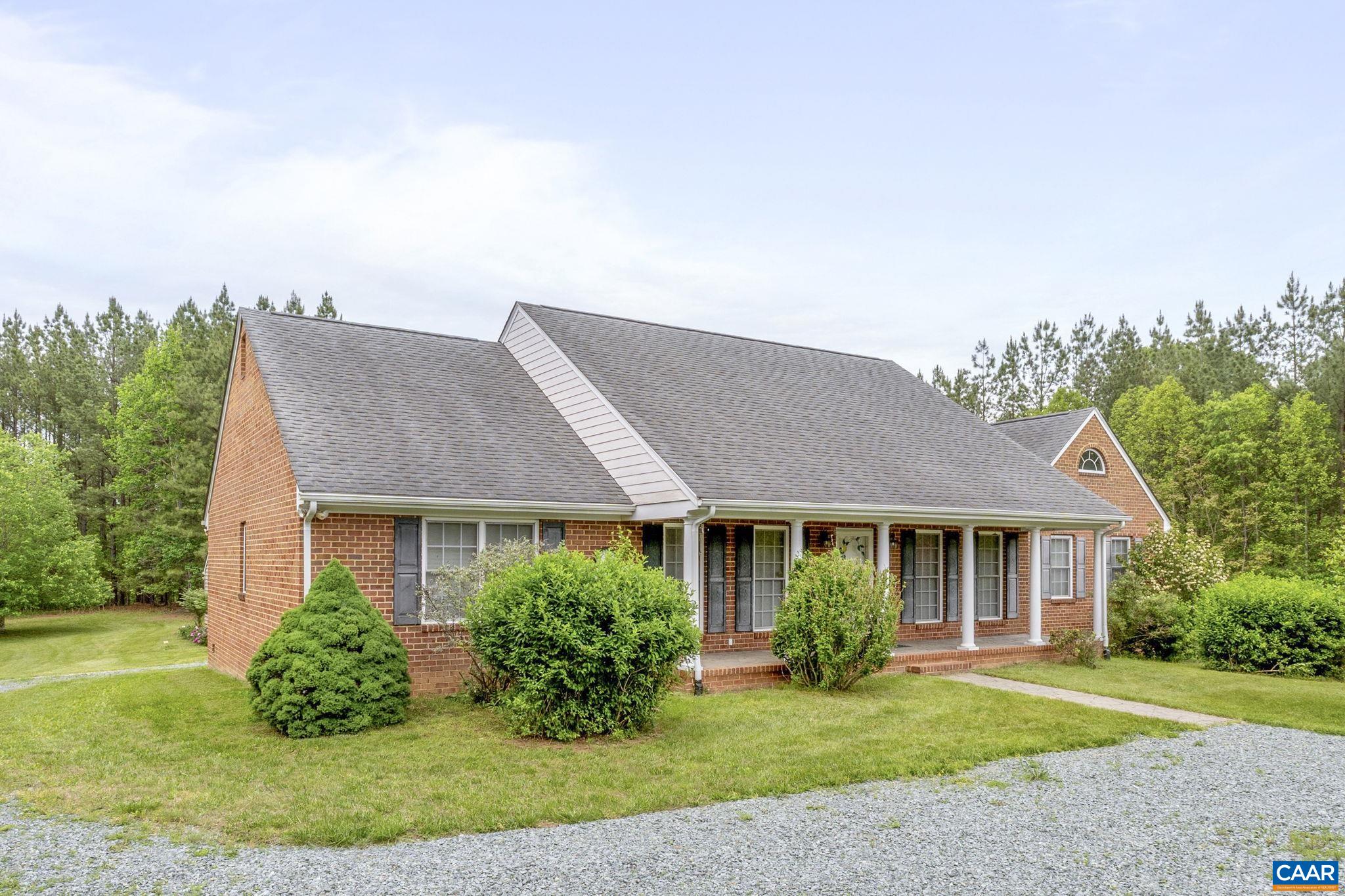 Private 20 acre retreat just 15 minutes to downtown, UVA and Charlottesville.  One level low maintenance brick home with oversized 2 car garage offers a comfortable blend of traditonal charm and modern living.  This beautiful spacious home boasts ample space and a layout designed for easy flow and relaxtion. Vaulted great room with gas fireplace and beautiful hardwood floors. Large four season room perfect for relaxing and enjoying nature.  Popular split bedroom design offers generous primary suite with ensuite bath and walk-in closet; 2 additional large bedrooms, home office and full bath.  Oversized detached 2 car garage with additional unfinished space could be workshop or finished off for additional living space.