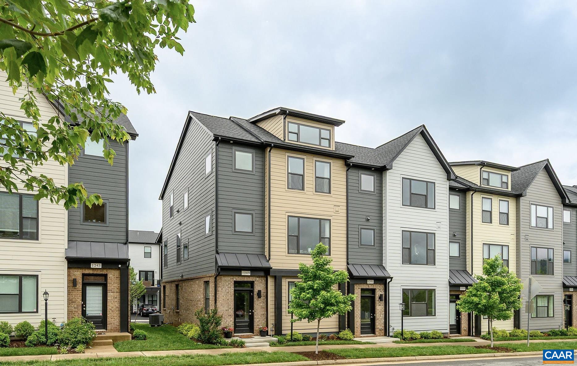 Don't wait to build! Start enjoying the best of the Old Trail experience now with this light-filled, end-unit townhome just steps from shops, dining, golf, community pool & trails. This spacious three-level home offers 4 bedrooms, 3.5 baths, & a flexible floorplan to suit your lifestyle. The main living level has model finishes to impress with an expansive 9' granite island, maple cabinetry, customizable refrigerator, hood vent, tiled backsplash, generous living room with fireplace & access to the 8x20 covered Trex deck w/mountain views—perfect for entertaining. Upstairs, the vaulted primary suite features a custom walk-in closet & a luxurious ensuite bath. Two additional bedrooms share a full bath with dual vanities, while the entry-level offers a 4th bedroom & attached full bathroom, also ideal as a home office or gym. The rear-entry two-car garage & included yard maintenance round out the conveniences. Live easy & connected in Crozet’s most walkable community