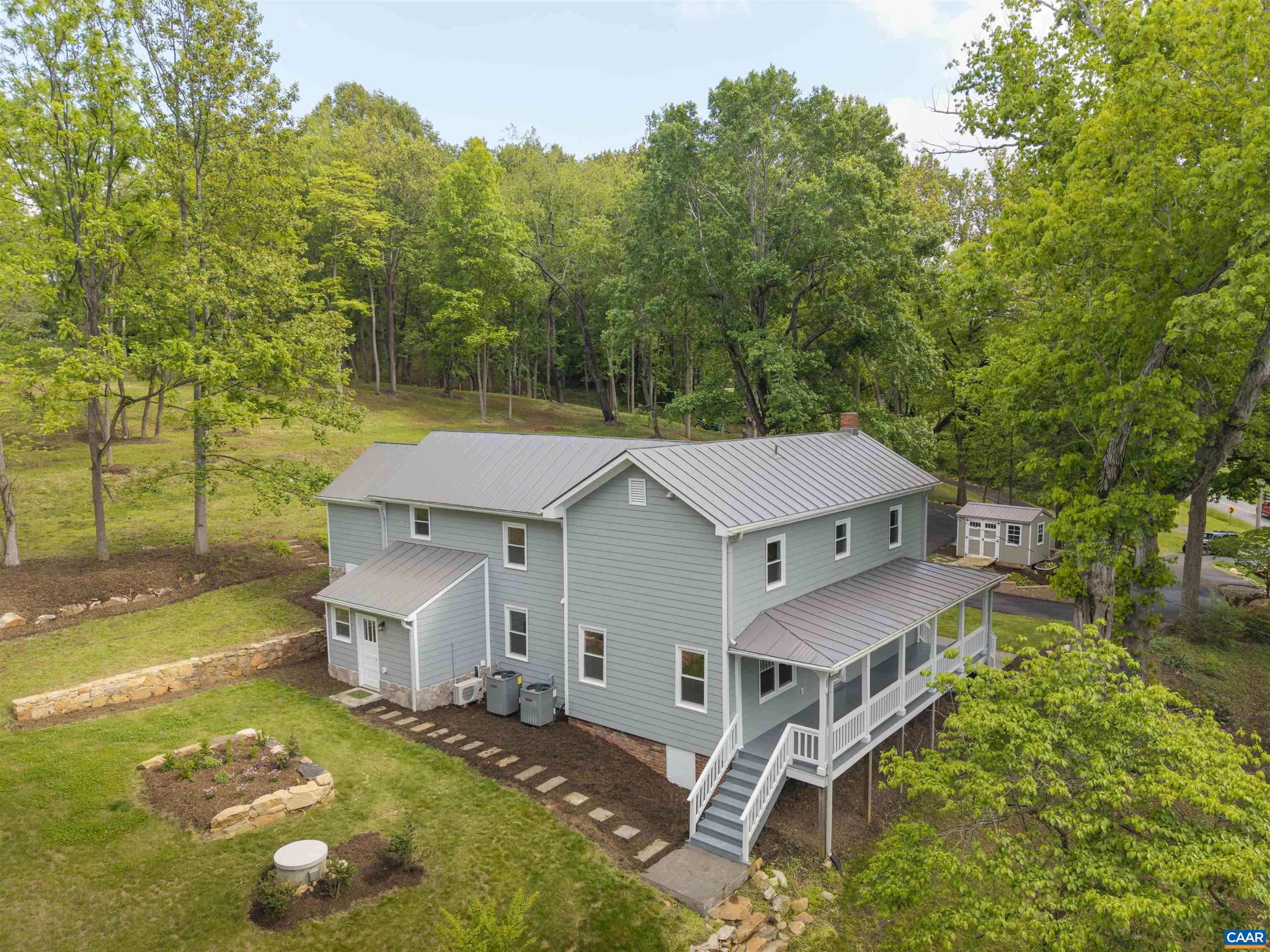 This charming 140+ year-old farmhouse sits on a lush 2-acre elevated lot, offering modern comforts with a quality renovation. Updates include new electrical, plumbing, ductwork, high-efficiency heat pumps, insulation, standing seam metal roofing, windows, siding, reclaimed heart pine and red oak flooring, and new cabinets. Original features like doors and hardware were carefully preserved, including century-old boards in the master suite. The 4-bedroom home has an open floor plan, spacious rooms, luxurious baths, and plenty of natural light. The farmhouse kitchen boasts new cabinets, a farmhouse sink with walnut and oak butcher block, and upgraded appliances, including a Sharp microwave drawer. Outdoors, enjoy extensive landscaping with brick walkways, a new patio, stone walls, terraced gardens, large hardwood trees, a paved circle drive with rock and retaining walls, and a classic front porch with views of the Hardware River. The property also includes potential for access to 26 acres with 2 miles of trails, perfect for birdwatching, wading in the river, or simply enjoying nature. Located 12 miles from the Rotunda, 5 miles from the Batesville Store, and 1 mile from Pippin Hill Vineyard, this is a rare find in today's market.