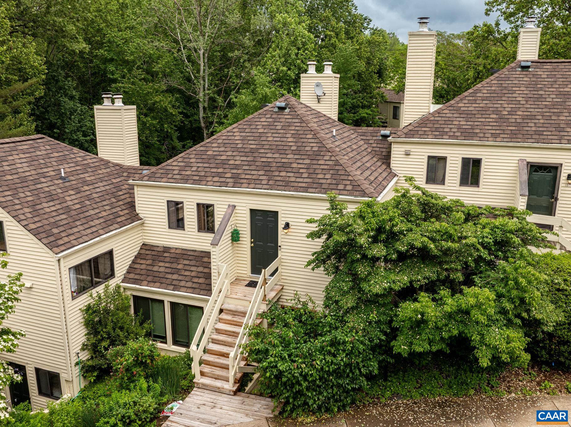 RIVER RUN – Bright & Charming Condo Living Awaits YOU! This updated condo offers the perfect blend of comfort and style~Freshly painted w/vaulted ceiling & a lot of natural light throughout, it feels warm & welcoming the moment you walk in~Enjoy a modern & updated kitchen w/great cabinets & cool concrete counters, stainless appliances, crisp Tile Floor & Backsplash~Cozy up by the wood-burning fireplace in the vaulted living room or step out onto your private rear deck—ideal for morning coffee or evening unwinding~Light-Filled Primary Bedroom includes a ceiling fan, pocket doors to the full bath, and stackable laundry~Extra storage via pull-down attic stairs. Enjoy new upgrades including a roof (2021), porch & deck (2024), and washer/dryer (2024). All & MORE so close to all community amenities and convenient to historic Downtown Mall & all local attractions Charlottesville has To OFFER~ Welcome HOME to Charlottesville - Make It YOURS to Own & Enjoy~River Run is pet-friendly with sidewalks, a community pool, and right next to Pen Park—golf, tennis, trails & more. A perfect place to call home!