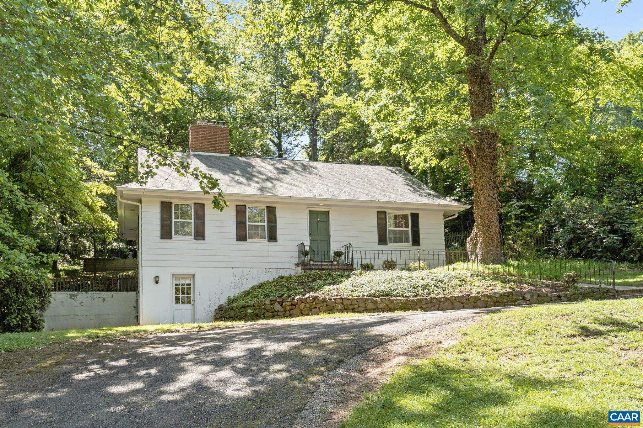 Meadowbrook Hills — Welcome to this charming and versatile home located in the city’s most prestigious neighborhood. Just minutes from everything Charlottesville has to offer, this rare opportunity is not to be missed. The main floor features two bedrooms and a full bathroom, perfect for easy, one-level living, in addition to a large, welcoming living room with a wood-burning fireplace. Original features add charm and warmth throughout, plus the ability to make the home your own without having to undo anything. Downstairs, the terrace level offers its own private living space, complete with a bedroom, full bathroom, living area, and kitchenette, ideal for guests, family, or rental income. Upstairs, a flexible second floor invites any number of uses: a home office, playroom, studio, or additional bedroom. The property is 0.37 acres in size and features a bluestone patio and stone wall in back. The house is move-in ready with endless opportunities to expand or renovate. Take advantage of a great value on a coveted street in a beloved neighborhood.