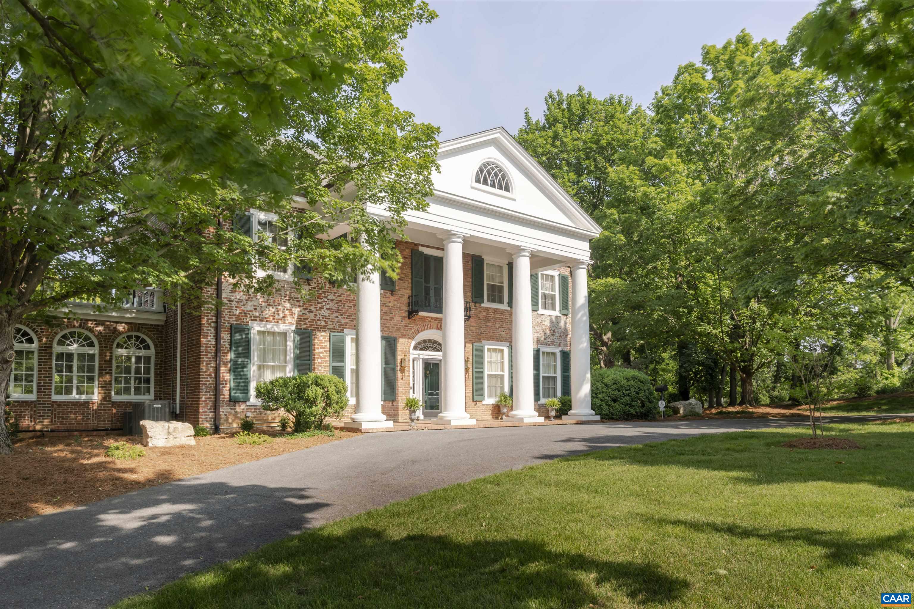 EDGE HILL, c.1835 — A distinguished architectural gem set on two manicured acres just minutes from historic downtown Staunton. Originally located in the city center, the home was meticulously deconstructed and reassembled in 1934 under the direction of architect Sam Collins. A grand three-story staircase anchors the interior, which features random width pegged oak floors, handcrafted Moravian tiles, and a richly paneled library by artisan Karl Protil. The main level offers formal and informal living and dining areas, an updated kitchen with custom pantry, guest suite, home office, and laundry. Upstairs, the primary suite boasts a fireplace, joined by two additional bedrooms, a full bath, and a covered porch. Two spacious bonus rooms occupy the top floor, while the finished lower level includes a bedroom, full bath, and 3-car garage. Also included is a fully renovated, income producing cottage at 1419 N. Augusta St., currently leased at $1,800/month — perfect for guests, tenants, or extended family.
