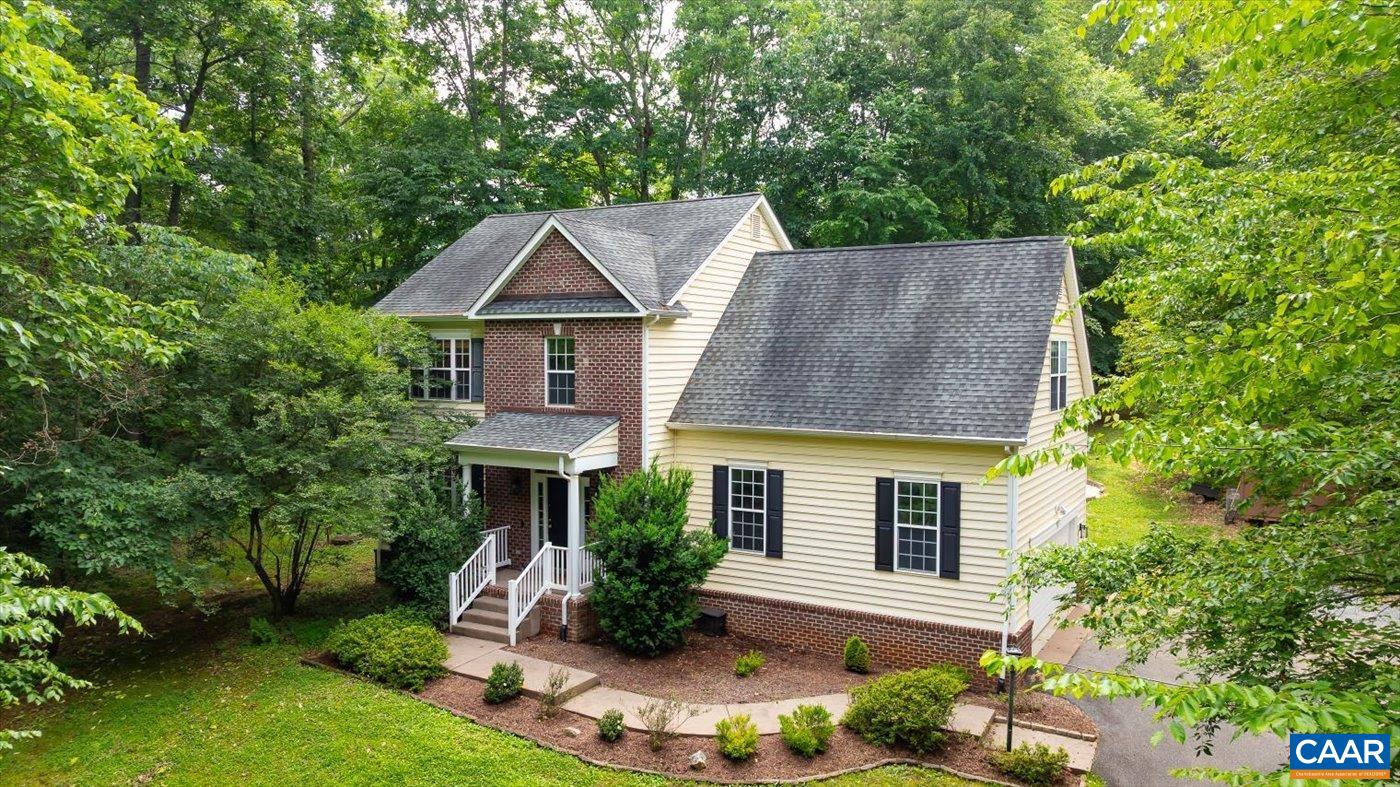 Welcome home to this beautifully updated property on Preddy Creek Road! Ready to move right in with brand new carpet and refinished hardwood floors and neutral paint throughout. The spacious living room with a gas fireplace flows into a large dining area.  A beautiful kitchen featuring a breakfast bar, granite, updated deep sin and 2022 stainless steel appliances.  Upstairs, the expansive primary suite includes a walk-in closet and en suite bath with dual vanities, a jacuzzi tub, and separate shower. Three additional bedrooms and a full bath complete the upper level. The oversized fourth bedroom with built-ins is perfect for a flex space, guest room, or home office.  The extra deep, tall attached garage offers plenty of space for two cars plus extra storage and a workspace.   Outside, enjoy a hot tub, chicken coop and run, storage shed, and wooded privacy. Just 5 minutes to Rt 29 and 10 minutes from NGIC, this home offers the perfect blend of convenience and privacy.