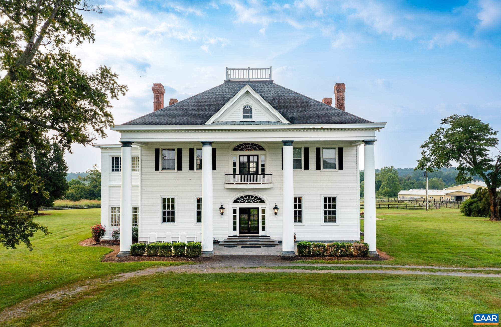 Greenfields Farm spans 495 acres just outside historic Scottsville, VA, with additional acreage available. A rare blend of rolling pasture, mature timber, and rich history, the property features a 1904 Colonial Revival main house with original architectural detail, a grand spiral staircase, arched transoms, and sweeping views from the widow’s walk. The residence offers copious amounts of living space, with three separate apartments and a caretaker’s home providing options for guests, staff, or extended family. Formerly a working horse farm, Greenfields includes fenced paddocks, a spring-fed creek, a stocked pond, a lake, and five wells. Equestrian facilities include a stable with 47 stalls, an indoor arena, a tack room, foaling stalls, grooming bays, hay storage, offices, and wash bays. Additional improvements include two equipment barns, grain silo, dog kennels, riding trails, and four gated entrances. With ties to Governor Wilson Cary Nichols and Lady Astor, Greenfields is a legacy estate of rare scale and beauty.