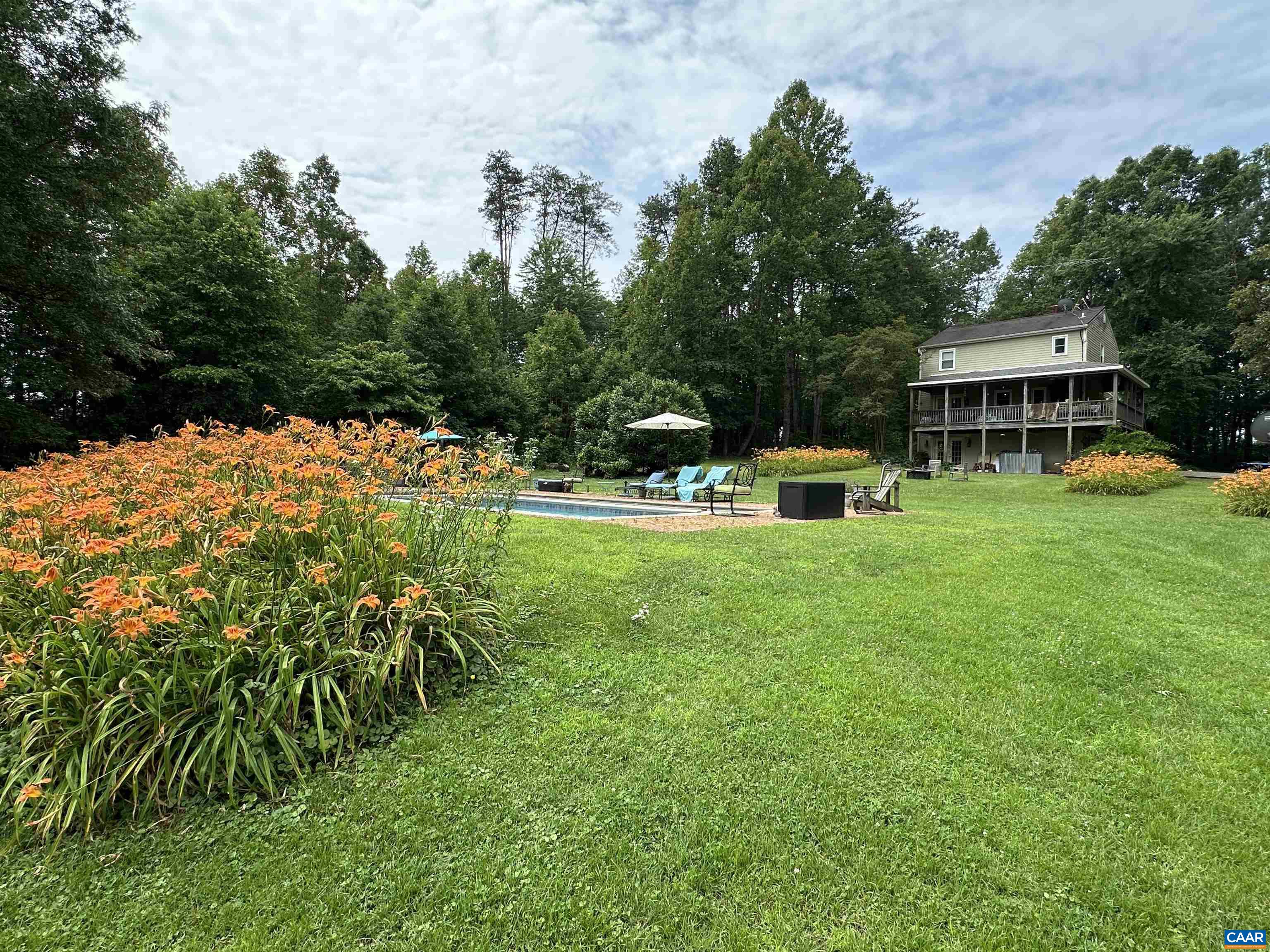Welcome to a serene and versatile property that seamlessly blends rustic charm with modern convenience.  Situated on 25.07 lush acres, this farm boasts a 2-stall barn complete with a wash stall, perfect for equestrian enthusiasts, and a chicken coop with a run. A tranquil pond adds to the picturesque landscape, offering a peaceful retreat. The property also includes a storage house with workshop space. The centerpiece is the main house, constructed in 1981.  It offers 2,206 square feet with three bright bedrooms and 2.5 baths. The living room, with a gas wood stove and built-in cabinets, leads to a kitchen updated in 2016 with stainless steel appliances and a central island. The dining area opens to a large deck, perfect for enjoying views of the pond, pool, and sprawling fields.  Complementing the main house is an 1800s cottage, meticulously rebuilt in 1987, providing a cozy getaway or an Airbnb option. This private oasis features a living room, kitchen, and loft bedroom with stunning views of the pond and farm.  A studio terrace apartment offers views of the pond, radiant heat flooring in the bathroom, and a sleek Angola Black Granite countertop. The property is enveloped by greenery and wildlife, providing a peaceful backdrop.