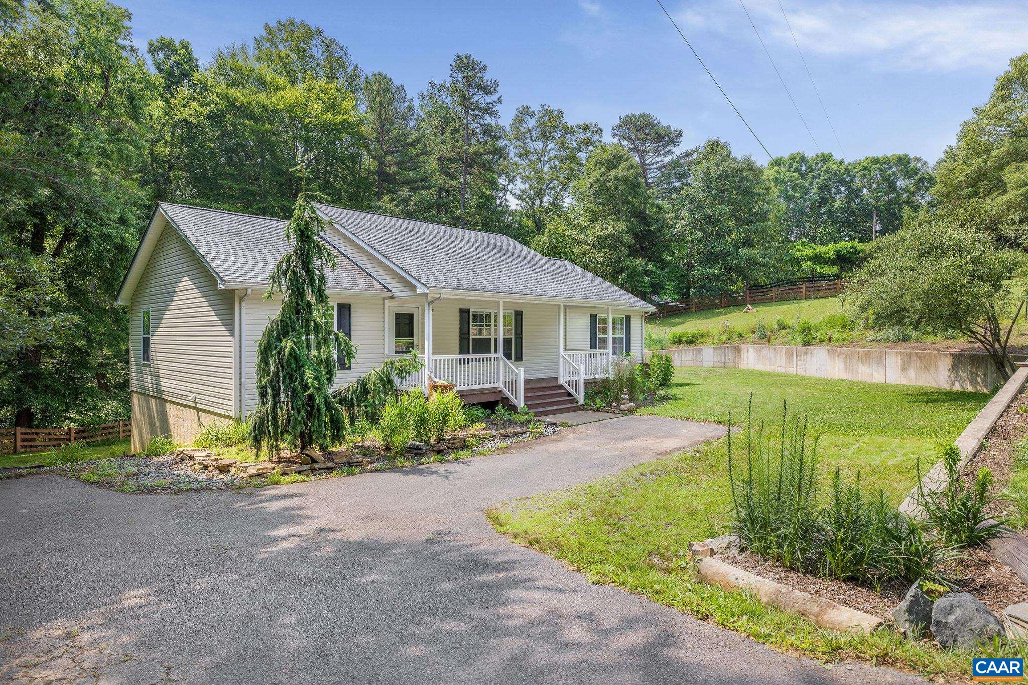 Peaceful Country Living: Tucked along a winding country road just 15 miles from the University of Virginia and 12 miles from Downtown Charlottesville, this inviting 3 bedroom/3 bath home offers a quiet, easygoing lifestyle without complete isolation. If you crave a sense of retreat after the workday, but don’t want to be too far from town, this home on 2 acres might feel just right.   Enjoy primarily one-level living with an open-concept kitchen, living, and dining area that feels both spacious and cozy. Downstairs, a full walk-out basement with a large full bath and flexible living space offers the potential for a 4th bedroom suite or studio-style apartment—ideal for guests, family members, or use as a private office or hobby retreat.  Multiple decks and thoughtfully planted landscaping invite you to linger outdoors and savor the slower pace. Interested in gardening? This is your spot.   With neighbors nearby—but not too close—you’ll appreciate the privacy without feeling disconnected. If proximity to CHO Airport is key, you're only 11 miles away. Easy to show, appointment required.