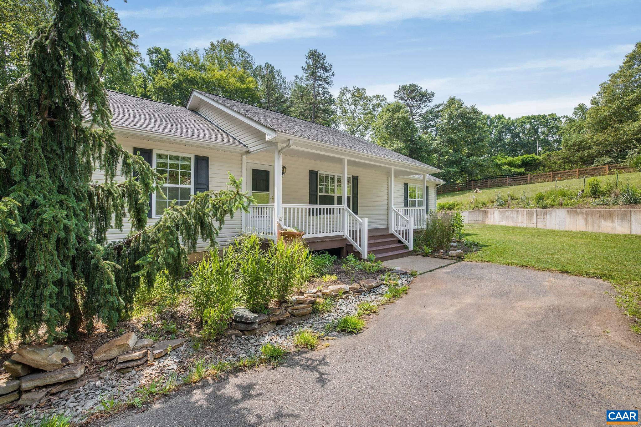 NEW PRICE! Peaceful Country Living: Tucked along a winding country road just 15 miles from the University of Virginia and 12 miles from Downtown Charlottesville, this inviting 3 bedroom/3 bath home offers a quiet, easygoing lifestyle without complete isolation. If you crave a sense of retreat after the workday, but don’t want to be too far from town, this home on 2 acres might feel just right. Enjoy primarily one-level living with an open-concept kitchen, living, and dining area that feels both spacious and cozy. Downstairs, a full walk-out basement with tall ceilings, a large full bath, and flexible living space offers the potential for a 4th bedroom suite or studio-style apartment—ideal for guests, family members, or use as a private office or hobby retreat.  Multiple decks and thoughtfully planted landscaping invite you to linger outdoors and savor the slower pace. Interested in gardening? This is your spot.   With neighbors nearby—but not too close—you’ll appreciate the privacy without feeling disconnected. If proximity to CHO Airport is key, you're only 11 miles away. Easy to show, appointment required.