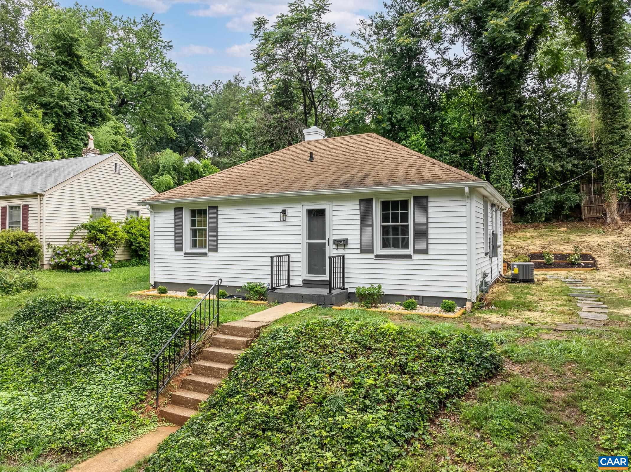 Wow! Completely renovated inside with new modern HVAC, new Tankless Hot Water Heater, new Kitchen, New Bathroom, new windows, new drywall and refinished floors! This charming cottage home tucked off of Rugby Road is surrounded by mature trees, with a newly landscaped and seeded yard. Inside, the cozy living room opens to the remodeled kitchen with quartz countertops, tile backsplash, white cabinets, and stainless steel appliances.  Everything is brand new! Two bedrooms share a full hall bathroom with new tiled floor and shower, new plumbing and a high-end washer/dryer combo hidden behind the sliding barn door! A flexible room next to the kitchen can be a home office, dining room or third bedroom.  New tankless hot water heater for instant hot water too! Enjoy the beautiful landscaping around the patio at the rear of the home. Don't miss your chance at this city charmer!