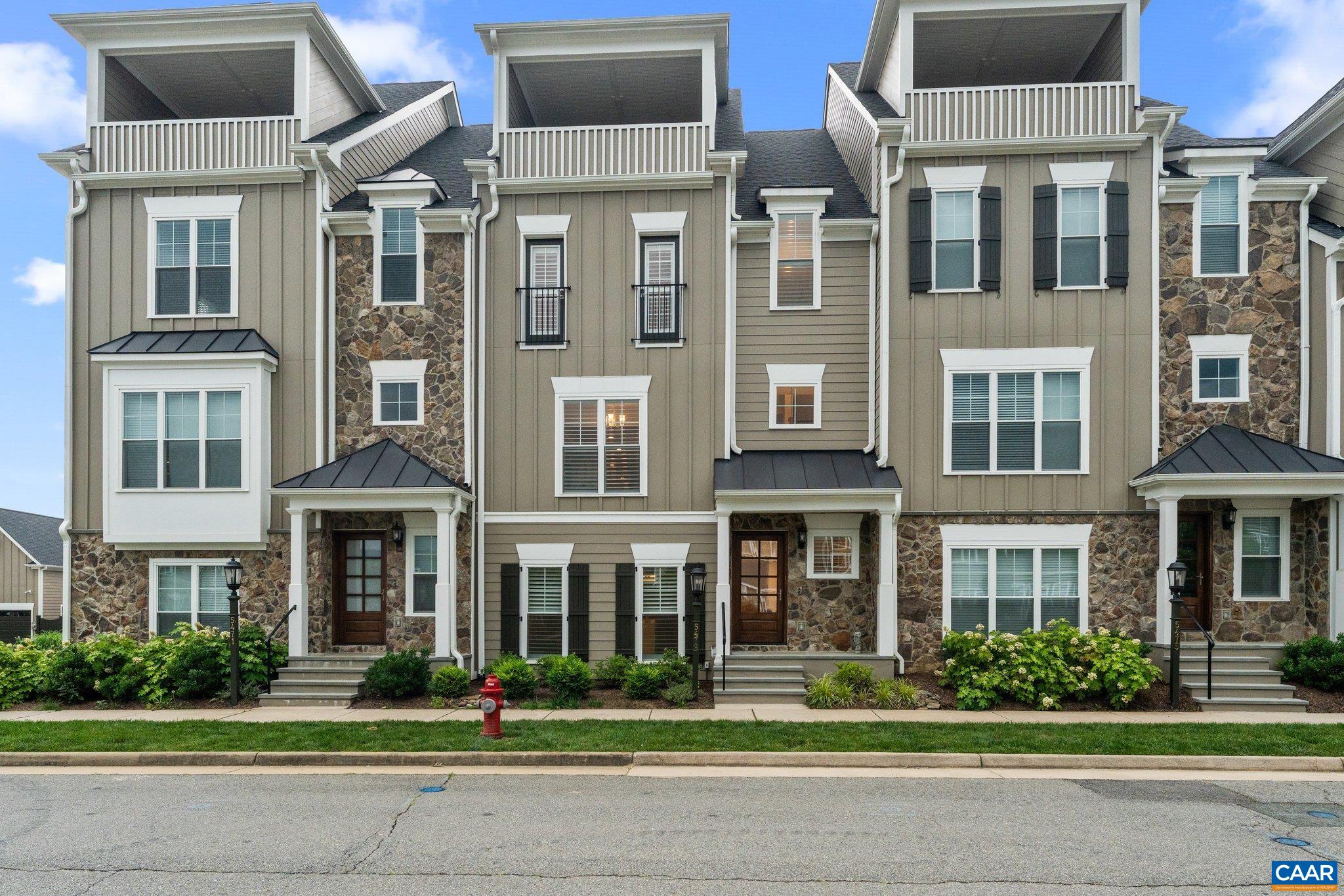 MOVE-IN READY townhome located in the center of Crozet’s Old Trail community  with a private ELEVATOR!   Beautifully maintained and thoughtfully designed, this home offers FOUR fully finished levels with luxury vinyl plank flooring throughout, combining style with durability.  Entry level features a versatile bedroom complete with en-suite, that would make perfect guest suite or office, and an area to drop bags and jackets just off the garage, and your private elevator.   Open and spacious main level features a light-filled living space with a gorgeous kitchen, oversized-quartz island, stainless appliances, and modern finishes. Living area centers on an electric fireplace, and access to a spacious screened porch.   Bedroom level hosts the primary suite with walk-in shower with dual shower heads, and separate water closet, an additional bedroom with ensuite, and a spacious laundry complete this level.  Stunning Blue Ridge Mountain views from the roof top level with a fourth bedroom suite and veranda.    Enjoy a lifestyle that comes with living in Crozet’s most walkable, amenity-rich community—featuring golf, pool, scenic trails, parks, and popular dining options.