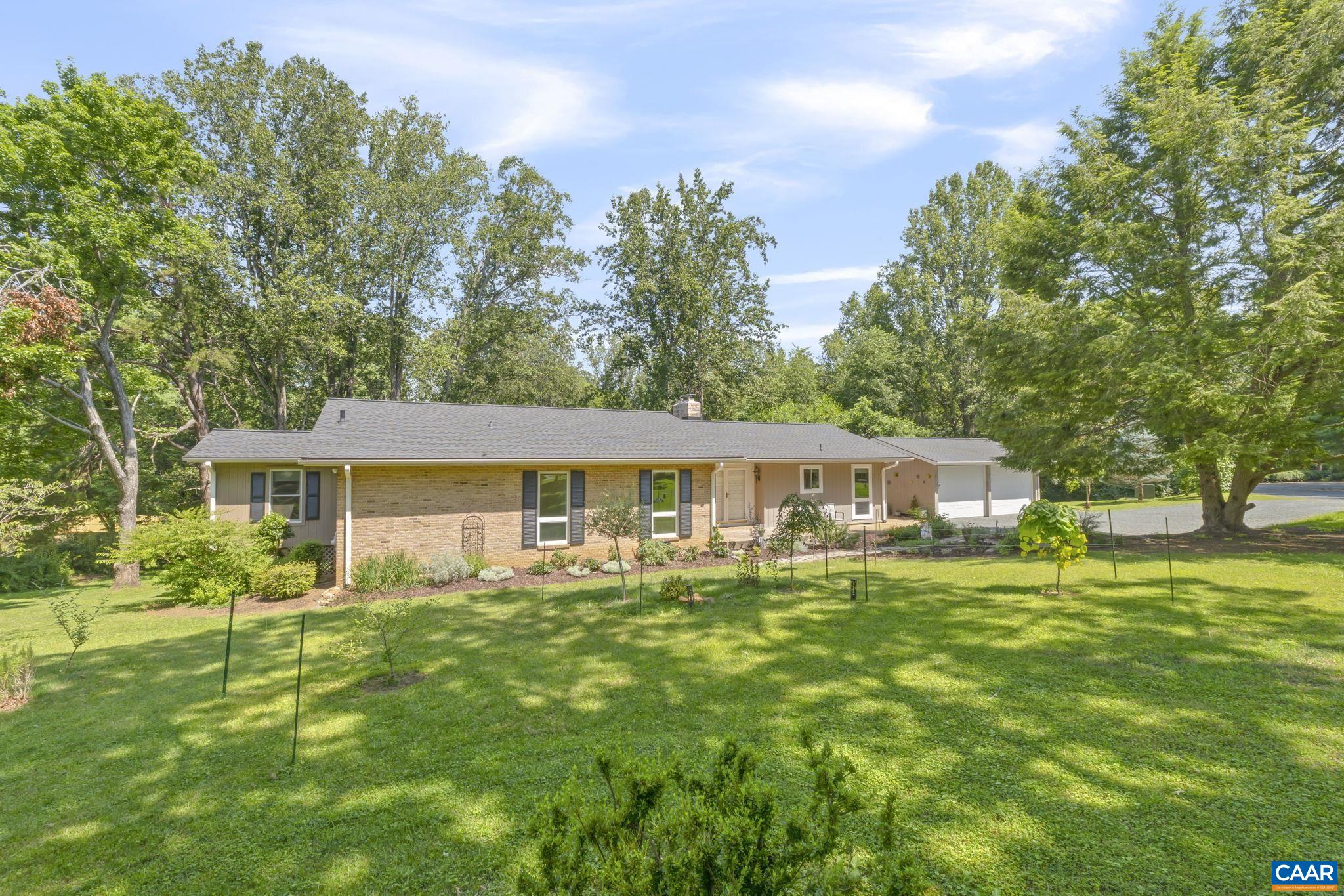 Hiding out on a quiet street in Carrsbrook, this mid-century gem offers space, privacy, and thoughtful updates throughout. The main level features 3 bedrooms and 2 full baths, including a spacious primary suite with an oversized walk-in closet that’s truly a dream for anyone who craves storage. With enough room for a full wardrobe, seasonal items, and more, it could even serve as a nursery or a private office. A massive 500SF sunroom overlooks the beautifully landscaped yard, an ideal year-round retreat. The kitchen, renovated in 2021, features a breakfast bar, built-in desk, & easy access to both the garage & a side patio, perfect for morning coffee. Downstairs, the terrace level is built for entertaining, w/ exposed wood beams, a wet bar, 4th bedroom, and guest bath. The slate-tiled covered lower patio easily fits both dining and lounge areas, and the fenced section of the yard includes a level lawn, enclosed garden, and storage shed. Extensive landscaping was added over the past two years, and every roof was replaced in 2024. With nearly an acre of space, including flat front and lower back yards and a 2nd shed, there’s room to play, plant, or practice your pitch. Whole-house generator guarantees year-round comfort.