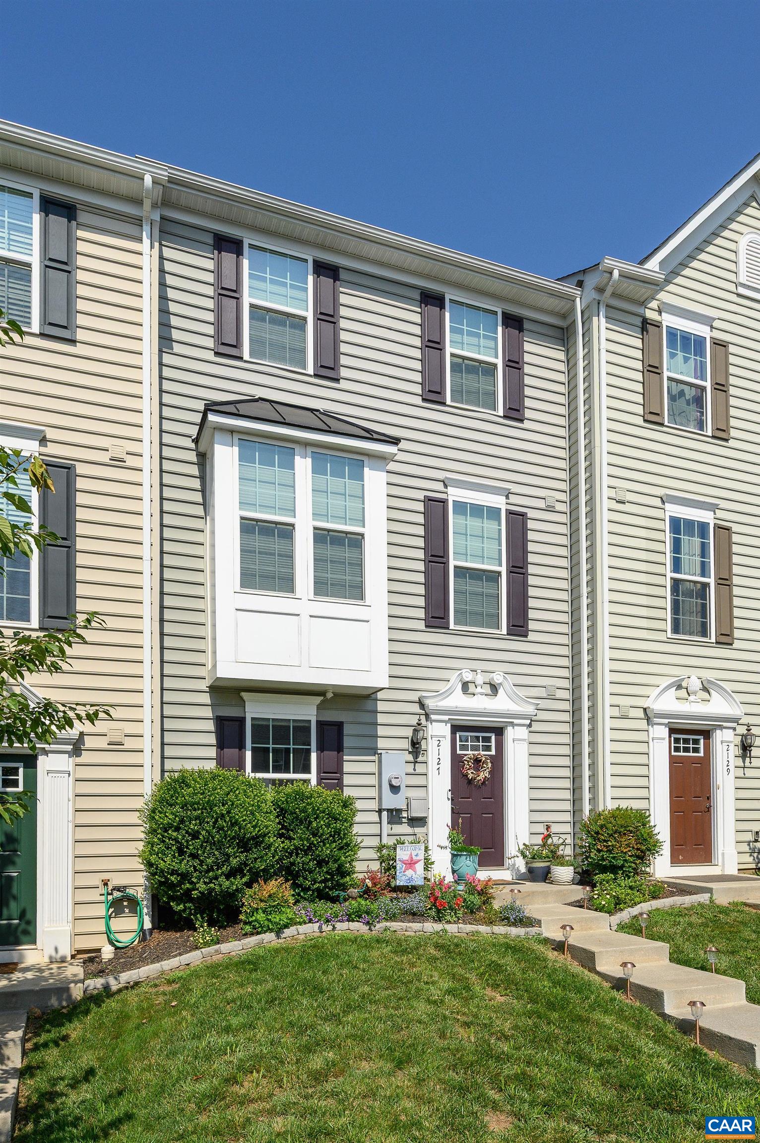 Welcome to 2127 Elm Tree Knoll, one of the largest townhomes in the Riverwood neighborhood, located conveniently across from NGIC, minutes from Hollymead Town Center and Cville airport, and less than 20 minutes to UVA and Downtown Charlottesville.  This like-new, one-owner home has been meticulously maintained and features a long list of upgrades.  Levels one and two, including both staircases, have gorgeous hardwood flooring, while the third level features nearly new carpeting.  In the gourmet kitchen you'll find timeless white cabinets with granite countertops, a generous island for gathering, a large pantry, and all new appliances.  During construction, owners extended the kitchen to include a built in bar and a spacious sitting area with a great view of the rear yard.  Other notable upgrades include an oversized primary bath with soaking tub and new shower doors, beautiful bay window in the living room, gas fireplace in the family room, custom blinds, closet organizers in the primary and guest bedrooms, and fresh paint throughout.  The rear yard is a relaxing oasis with a new trex deck, fencing on both sides for privacy, and beautiful landscaping.  HOA covers lawn care in the front.  Wonderful playground in the neighborhood!