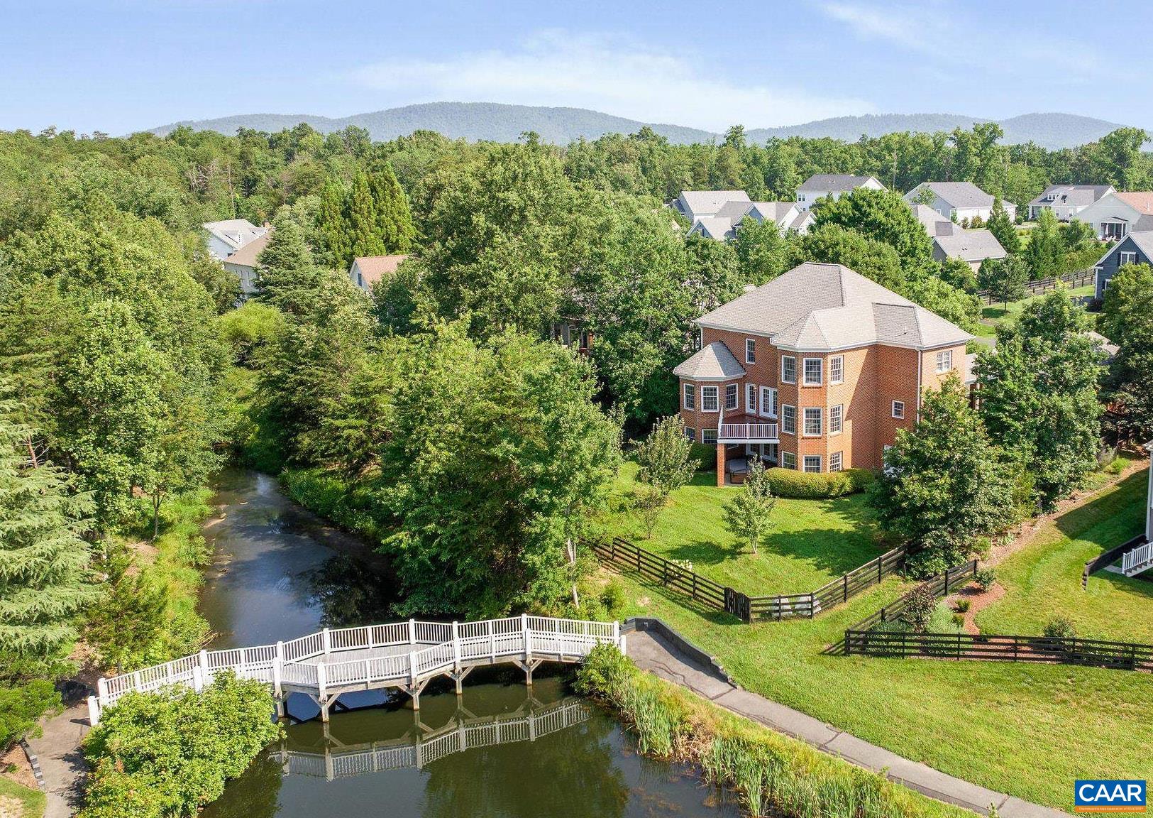Unique and eco-conscious, this all-brick home offers serene views of Glen Lochan Pond in the heart of Glenmore. With five bedrooms and generous living spaces, it blends classic design with modern comfort. The main level features formal living and dining rooms, a spacious eat-in kitchen with water views, a sunlit family room, and a versatile flex space. Upstairs are four bedrooms, including a large primary suite with a renovated bath. The walk-out basement includes a living area, kitchenette, office, guest bedroom, full and half baths, and access to a six-person Bullfrog spa with ECOsmarte chlorine-free system. The fully fenced yard showcases native pollinator gardens, a small herb garden, fruit trees from Edible Landscaping, and professionally designed landscaping plans from The Natural Garden. Eco features include a rain barrel, garage EV charging, Arcadia Power solar credits, and participation in Envirocycle and Black Bear Composting. Purchasers receive a 25% discount on initiation to the Club at Glenmore.