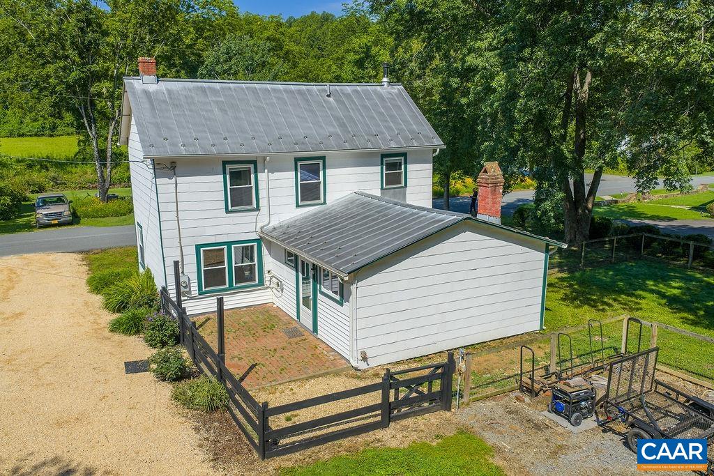 Beautifully renovated 1900 farmhouse in the heart of Batesville, just steps from the Batesville Store and across the street from creek and walking trails. This 3BR/2BA home features a main-level bedroom and has been thoughtfully updated while preserving its historic charm. The kitchen boasts marble counters, heated soapstone floors, new cabinetry, and appliances. Major upgrades include a 100-year metal roof, zoned HVAC with whole-house air filter, UV water filtration, new well pump, new windows, and an EV charger. The fenced yard is seeded with low-mow grass, and there's a bike/garden shed, cedar-lined closet, lined chimney with woodstove, and custom built-ins. Recent siding repairs and cedar trim maintenance completed in 2025. A rare blend of character, comfort, and community in one of Albemarle’s most picturesque villages.