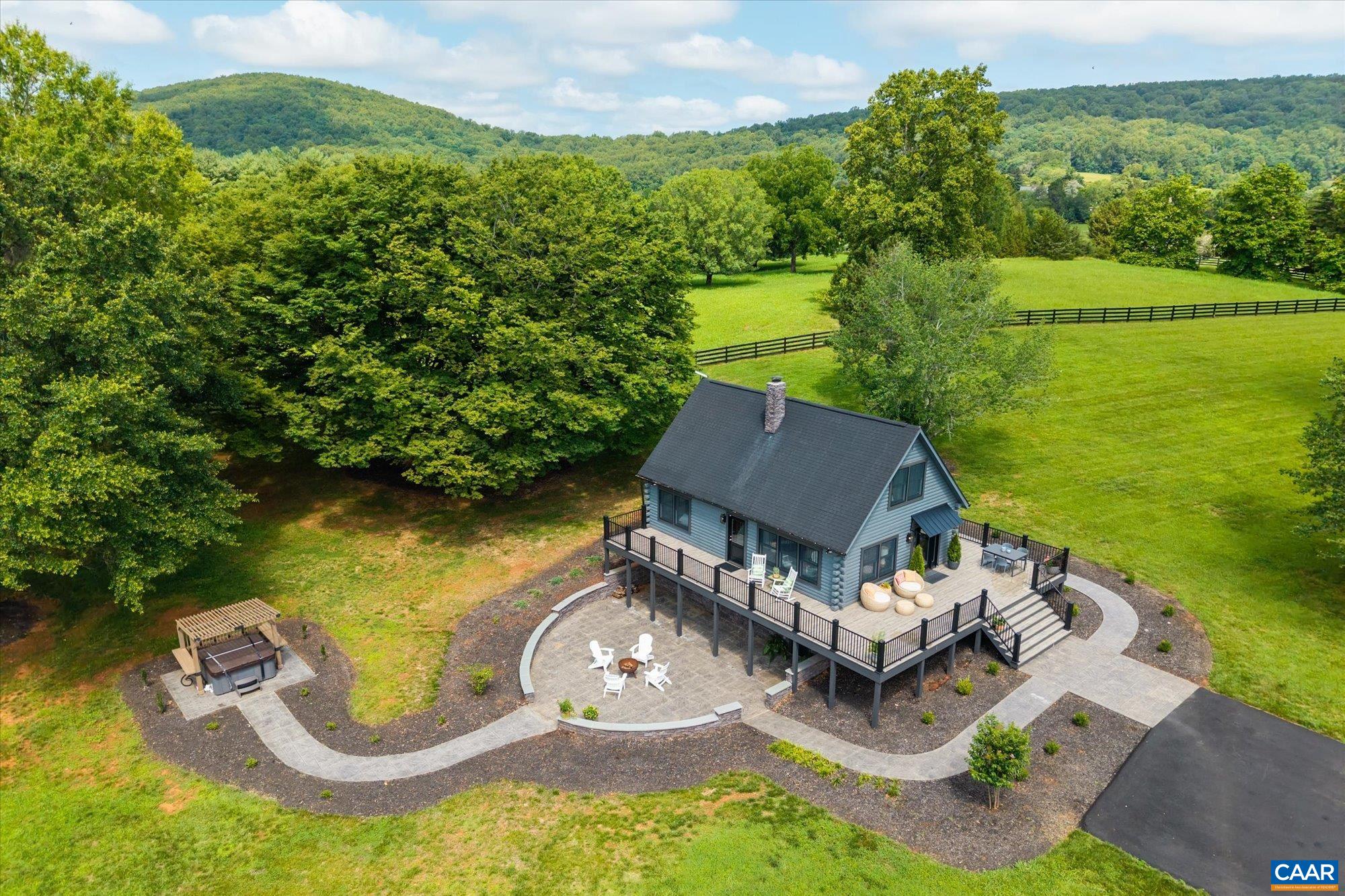 A Rare Albemarle County Retreat- Where Luxury Meets Virginia Wine Country. Your opportunity to own a stunningly restored log cabin retreat nestled on 7.56 bucolic acres in the heart of Albemarle County. Just minutes from Charlottesville and surrounded by the region’s most celebrated wineries, cideries, & the enchanting Historic Morven Gardens, this turnkey 4-bedroom home offers a blend of rustic charm & modern luxury. Reimagined by interior designer Karen Ward, ASID, the home showcases fine craftsmanship & bespoke finishes throughout. Every detail is brand new-- the windows and doors to the custom wood cabinetry, designer lighting, & high-end materials. The spa-like bathrooms feature imported Italian and Spanish porcelain walls & flooring, delivering comfort & style. Step outside onto the expansive wraparound deck/rails where Kronos porcelain pavers create the ideal setting for outdoor entertaining or quiet morning coffee. Located just moments from Gabriele Rausse Winery, Carter Mountain Orchard’s charming wine shop, & the acclaimed stops along the Monticello Wine Trail—including Jefferson Vineyards, Blenheim Vineyards, and Trump Winery—this property is a rare jewel in one of  in one of Virginia’s most picturesque settings.