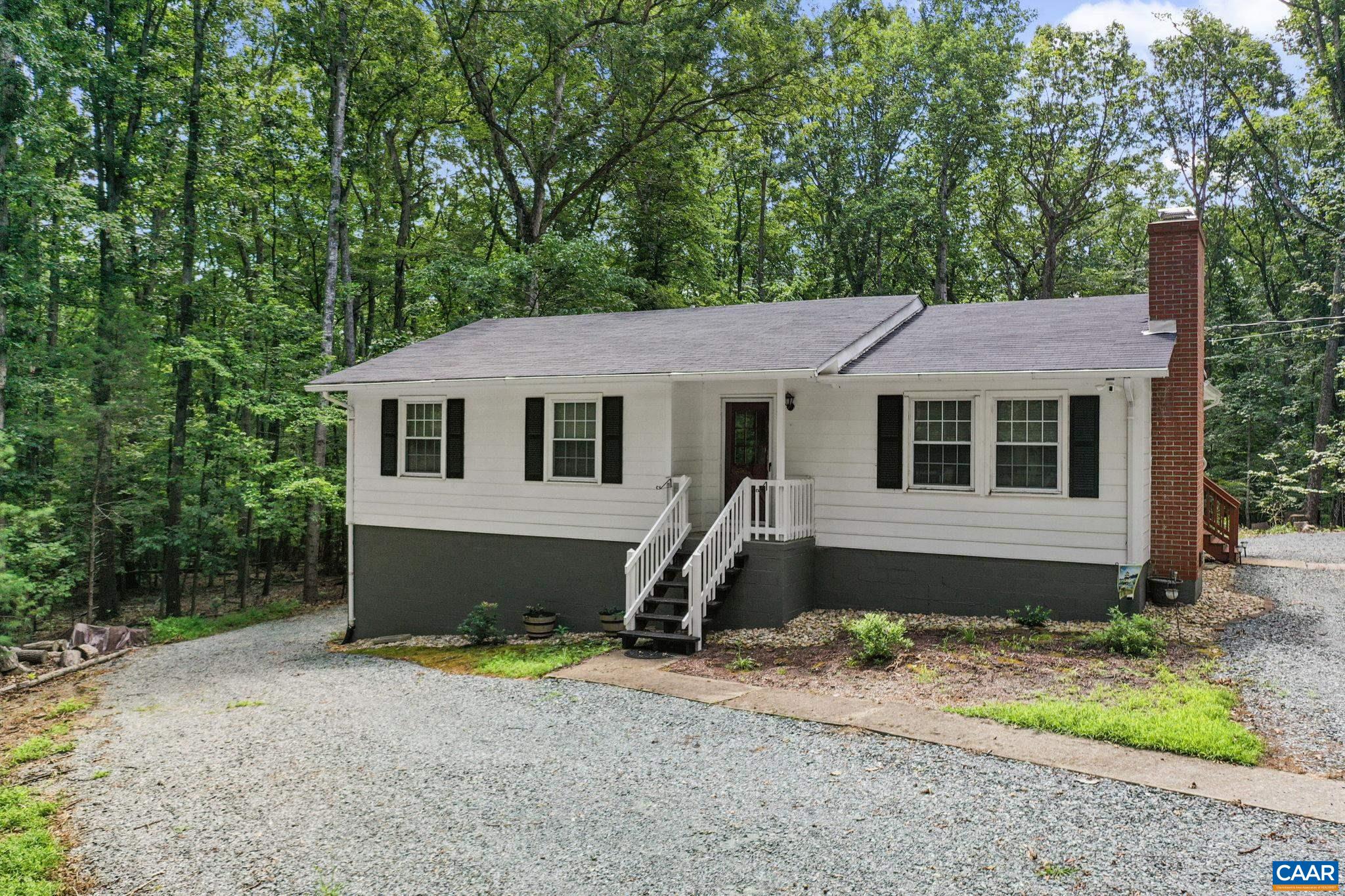 Immaculately maintained rambler on 2.43 private acres with fully finished walk-out basement! This move-in-ready home offers the perfect blend of peaceful living and convenient access to everything Charlottesville has to offer. Nestled on a spacious lot with a wraparound driveway and ample parking, this property is ideal for both relaxing and entertaining.  Enjoy your mornings on the large covered 16' x 20' deck overlooking the serene yard with beautiful mature hardwoods. Recent upgrades include a new roof (2021), recently replaced HVAC system, and a beautifully renovated main-level bathroom (2025). The fully finished basement features its own private entrance and laundry hookups—perfect for guests, multi-generational living, or potential rental income. Don’t miss this rare opportunity to own a meticulously cared for home with modern updates, privacy, and unbeatable convenience!