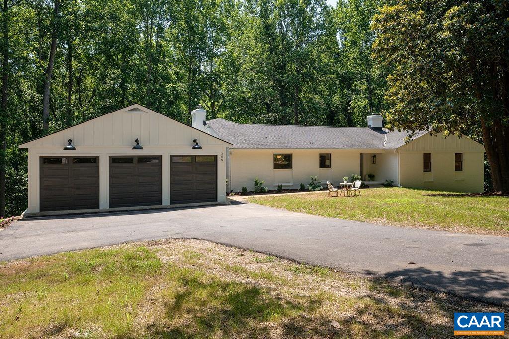 Exceptional whole-house renovation & expansion has transformed this timeless Mid-Century gem into a luxurious, move-in ready home in ultra-convenient Montvue. Set on 3.2 acres w/ open lawns & mature woods down to a stream, this property offers rare privacy & convenience, just 7 mins to Barracks Rd. & Stonefield amenities. Gorgeous new kitchen w/ shaker cabinets, quartz counters, marble backsplash, 3x8 birch island, 36" gas range, custom hood & stainless appliances. Elegant main-level primary suite w/ new private deck overlooking woods/stream & deluxe bath featuring Carrera marble, glass shower, & double vanity. Additional features: new 3 car garage, 2 new heat pumps, natural finish oak floors on main level, custom mudroom/laundry, delightful screened porch, spacious living areas w/ treehouse views, fresh interior & exterior paint, all new baths, lighting & plumbing fixtures. Septic sized for 3 bedrooms/6 people. See docs for full list of impressive renovation details!