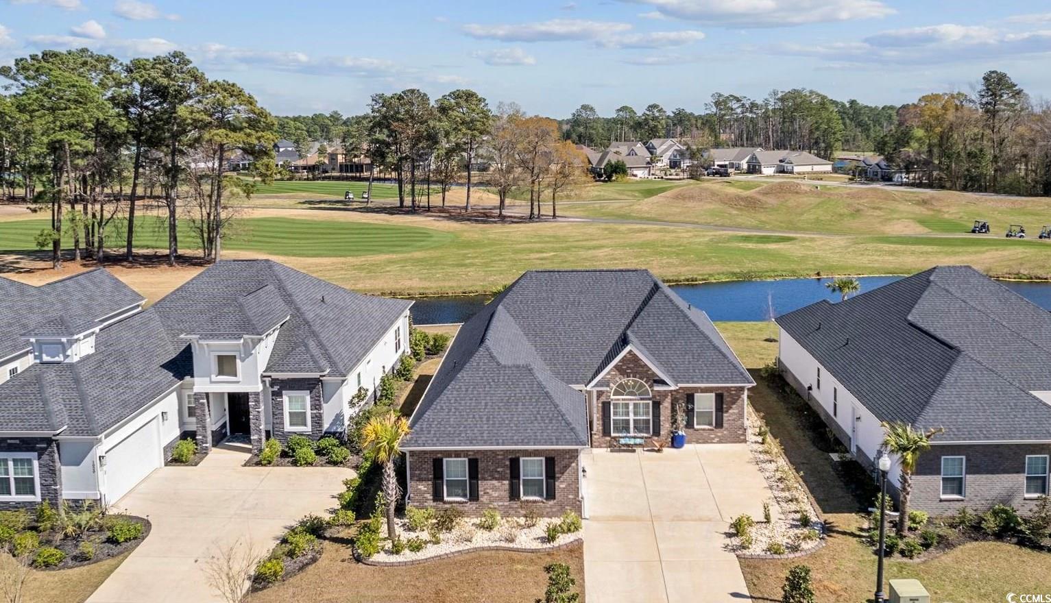 Open House Sunday, 12/8/24 from 11:45AM to 1:30PM. No fault of sellers, back on the market. Have you ever dreamed of living in a better than new home built by a local award-winning builder, overlooking a lake and a championship golf course? Well now is your chance. Don’t miss this rare opportunity to own this better than new, 2-year-old 4-bedroom home with masonry accents, loaded with features not found in similar homes in the highly sought-after lake front community of Wild Wing Plantation.   The stately front entrance and covered front porch welcomes you into this bright sunny breathtaking home with an open floor plan that accents the stunning views of the lake and the Wild Wing Plantation Avocet championship golf course. The Living Room has spectacular double tray ceilings, and an attractive ceiling fan to help cool you off on those warm summer nights. Gorgeous waterproof luxury vinyl plank floors flow through the main living area, dining room, 4th bedroom/study and into all the wet areas of the home. The large, covered rear porch boasts stunning lake and the golf course views. The gourmet chef’s kitchen includes solid wood kitchen cabinets with dovetail construction, soft close hinges, crown molding, upgraded granite counter tops, stainless steel appliances, microwave range hood, smooth top stove, walk-in pantry, a breakfast nook and even a counter height oversized island bar. The home has two ample sized guest bedrooms, a shared bathroom with double vanity and combination tiled tub/shower. The master bedroom suite offers views of the lake and golf course, has a double tray ceiling, crown moldings, ceiling fan, large walk-in-closet, his/her sinks, separate vanity area, walk-in tiled shower w/glass door, and private commode. The 4th bedroom/study, with French door entrance features a large palladium window that lets natural light fill the room. The oversized laundry room has a washer/dryer that will convey with a strong offer. The home has a finished/painted 2 car side load garage, with pull down attic storage.   Structurally this home has several features that showcase the high quality of construction of the home. The home has enhanced roof rafters, upgraded architectural roof shingles and wide door and window trim. The owner recently added plantation shutters to windows of the home. The meticulously maintained professionally landscaped .38-acre yard features newly installed curb scaping, multiple black mulched flower beds, attractive palm trees, eye catching plants and bushes. The home has a fully automatized irrigation system with water conservation nozzles and gutters.    Wild Wing Plantation has a private boat ramp that gives you direct access to the large 180-acre lake, where you can use your own boat to explore the lakes, fish, take in nature and the SC lake birds, including blue heron, egrets, native swans and even eagles. Take your boat to the clubhouse to also enjoy the many amenities there. Association amenities include large clubhouse, fitness center, multiple outdoor pools, hot tub, 80’ waterslide, tennis/pickle ball courts, basketball court, fenced in playground area, huge day dock, private boat ramp and boat/RV storage. Owners have access to the Wild Wing Plantation golf course/country club, Players Pub restaurant, offering up dining, cocktails or craft beer with large wrap around bar. The Wild Wing restaurant offers weekly community, lunch/dinners, live music, dancing, and special entertainment designed specifically for the Wild Wing Plantation owners to enjoy.   Be sure to have your Realtor® ask about the current Wild Wing Golf Club membership opportunities! Wild Wing Plantation offers convenient easy access to Coastal Carolina University, shopping, the beaches and all that Myrtle Beach and Conway has to offer.   Don’t miss out on this rare find, have your Realtor® schedule a showing today!!! All measurements, square footage are approximate and not guaranteed. Buyer is responsible for verification.