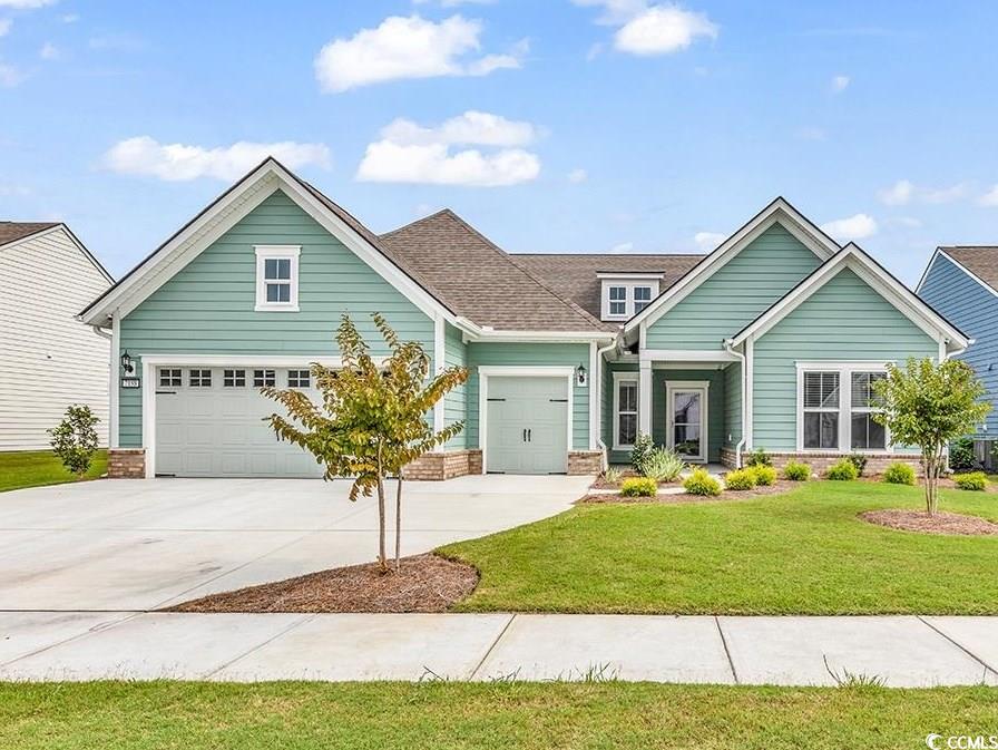 Why wait to build? This home is like new and on a quiet lake lot - Welcome to Del Webb, Grande Dunes Premier 55+ community. . This stunning 3-bedroom, 3-bath home is nestled on a quiet lake lot. The highly sought-after Dunwoody floor plan was built in 2023 and is move in ready.The home offers an open-concept kitchen, dining area, bright great room and Carolina room. You will enjoy the white kitchen cabinets with quartz countertops, stainless steel appliances, gas stove and specialty work station kitchen sink. The flex room in the front of the home can be the office/study or workout room and features custom wall to wall built ins. Enjoy tranquil water views from the entire main living area and the primary bedroom. The great room is perfect for your gathering space and is open to the kitchen and the sunny carolina room. The spacious primary suite offers lots of natural light and also has wood laminate floors. The bath has a tiled shower with bench, double vanity with beautiful quartz counters, linen closet and an expansive walk-in closet. With 2 additional bedrooms, it is the perfect size home. The laundry room offers a drop zone and access to the large garage. If you love the sectional sofa or the dining room table and chairs, the owner is willing to discuss. The oversized 2 car attached garage also includes a 3rd bay for the golf cart and is finished off with polyaspartic floors which are an upgrade from epoxy floors. The Del Webb amenities are unparalleled, offering a vibrant active community experience. Meet new friends at the monthly events and daily activities hosted at the Amenity Center, Enjoy swimming at the indoor pool or outdoor pool, workout at the gym,  or play pickle ball, and tennis. This Del Webb community includes membership to the luxurious Grande Dunes Ocean Club. This oceanfront resort offers swimming, clubhouse, and access to the beach. Conveniently located close to the beach, shopping, hospital, doctor’s offices and much more.