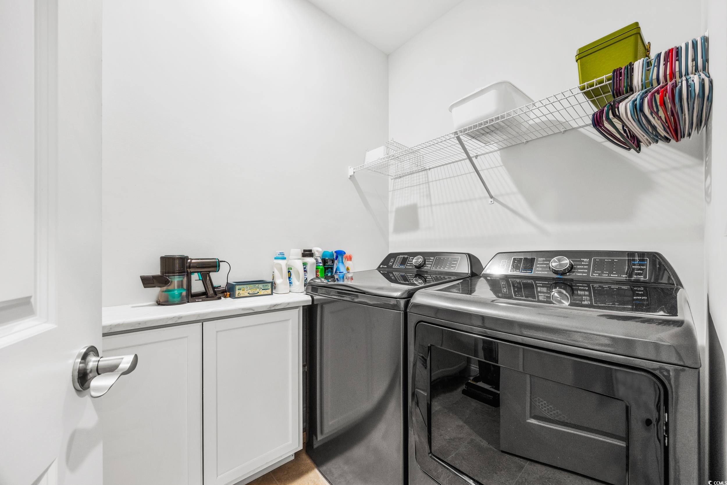 Laundry room with cabinets and separate washer and dryer
