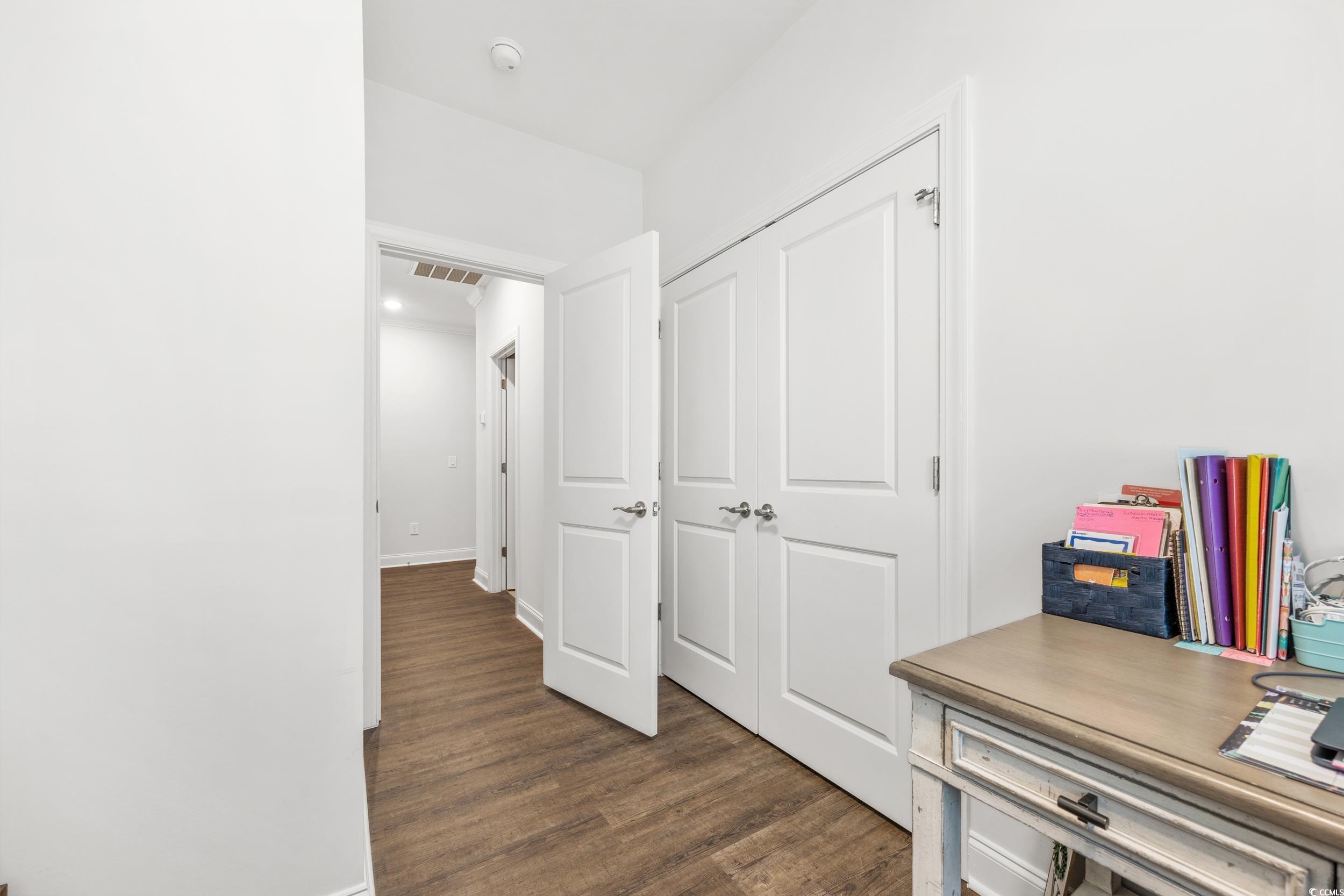 Hall with dark wood-type flooring