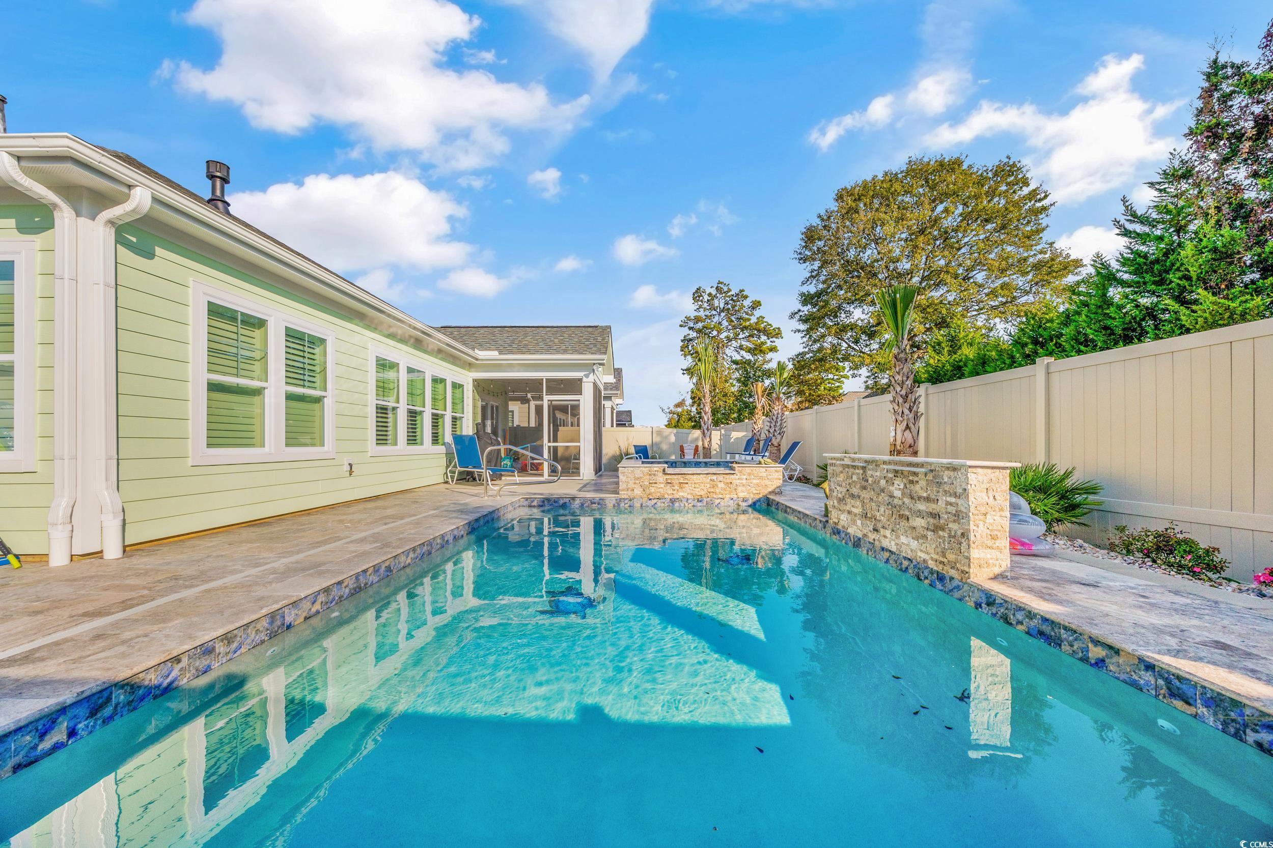 View of pool featuring a patio and a sunroom