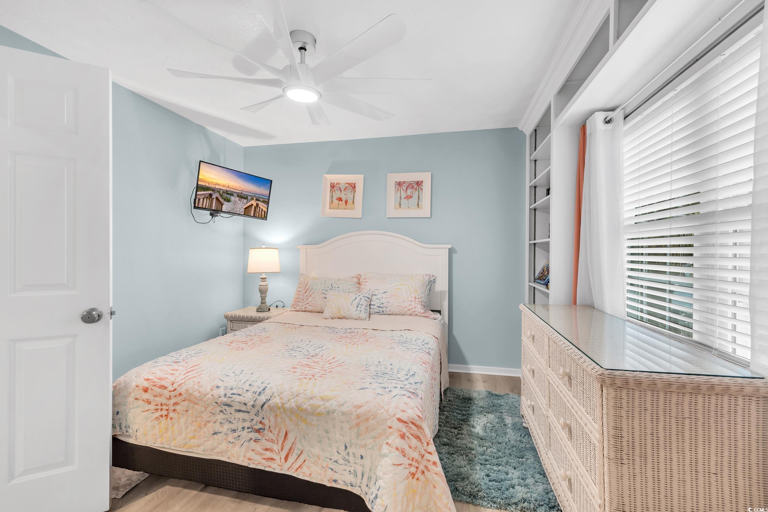 Bedroom featuring ceiling fan and light wood-type flooring