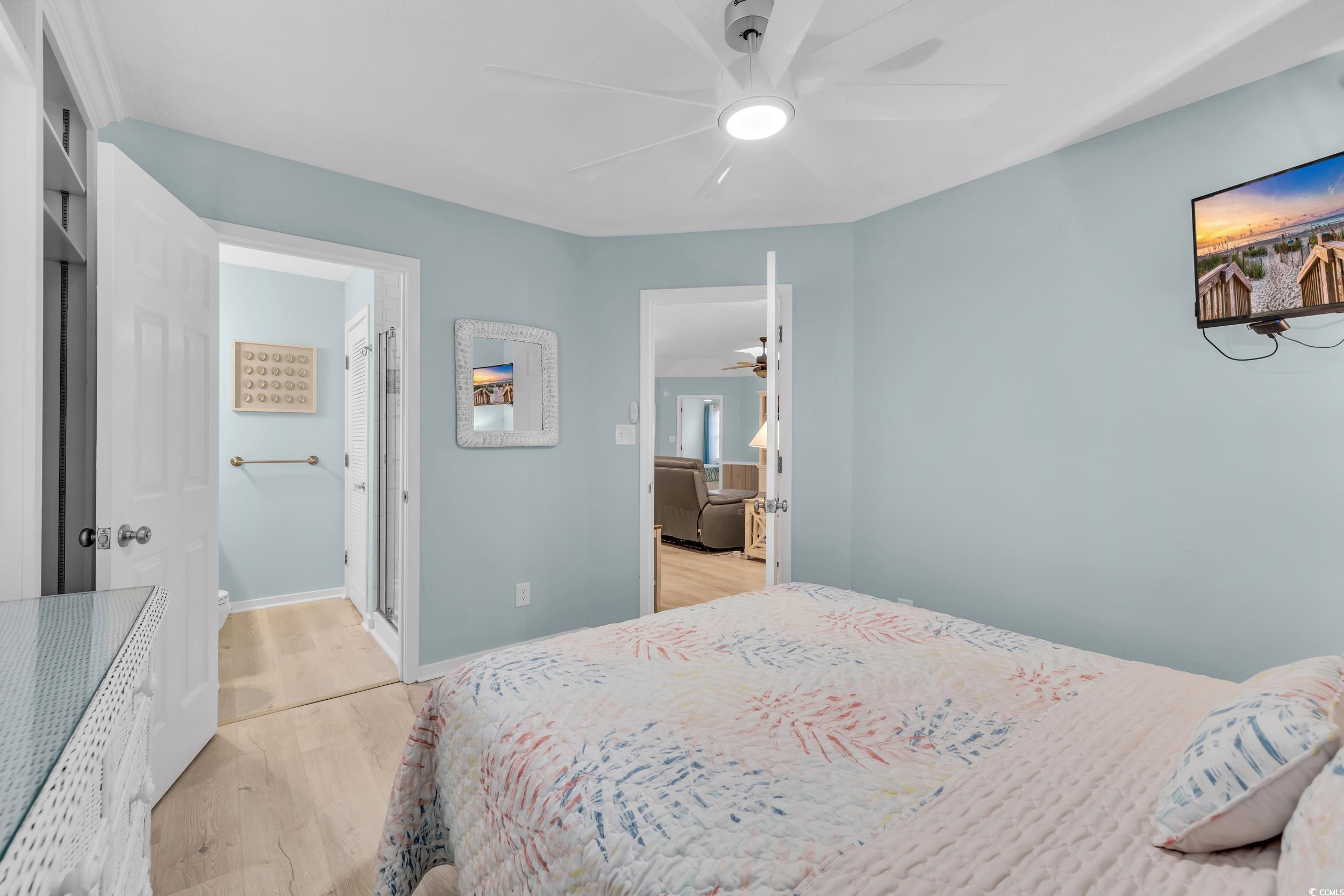 Bedroom featuring ceiling fan and light hardwood / wood-style floors