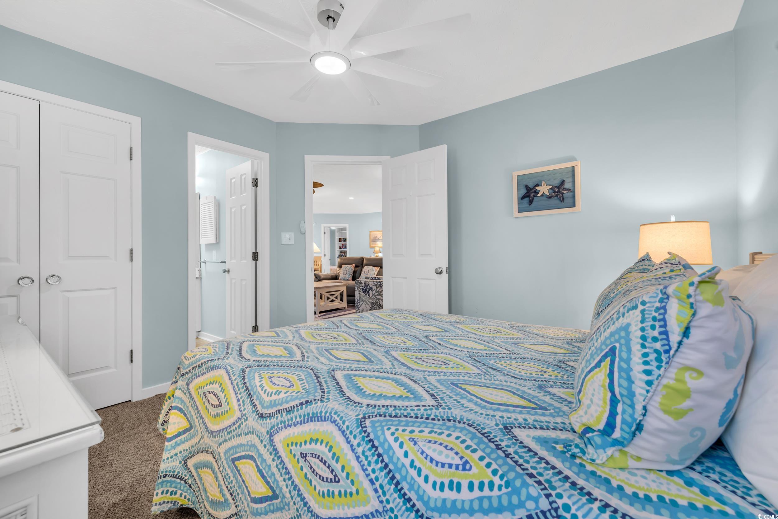 Bedroom with carpet flooring, ceiling fan, and a closet