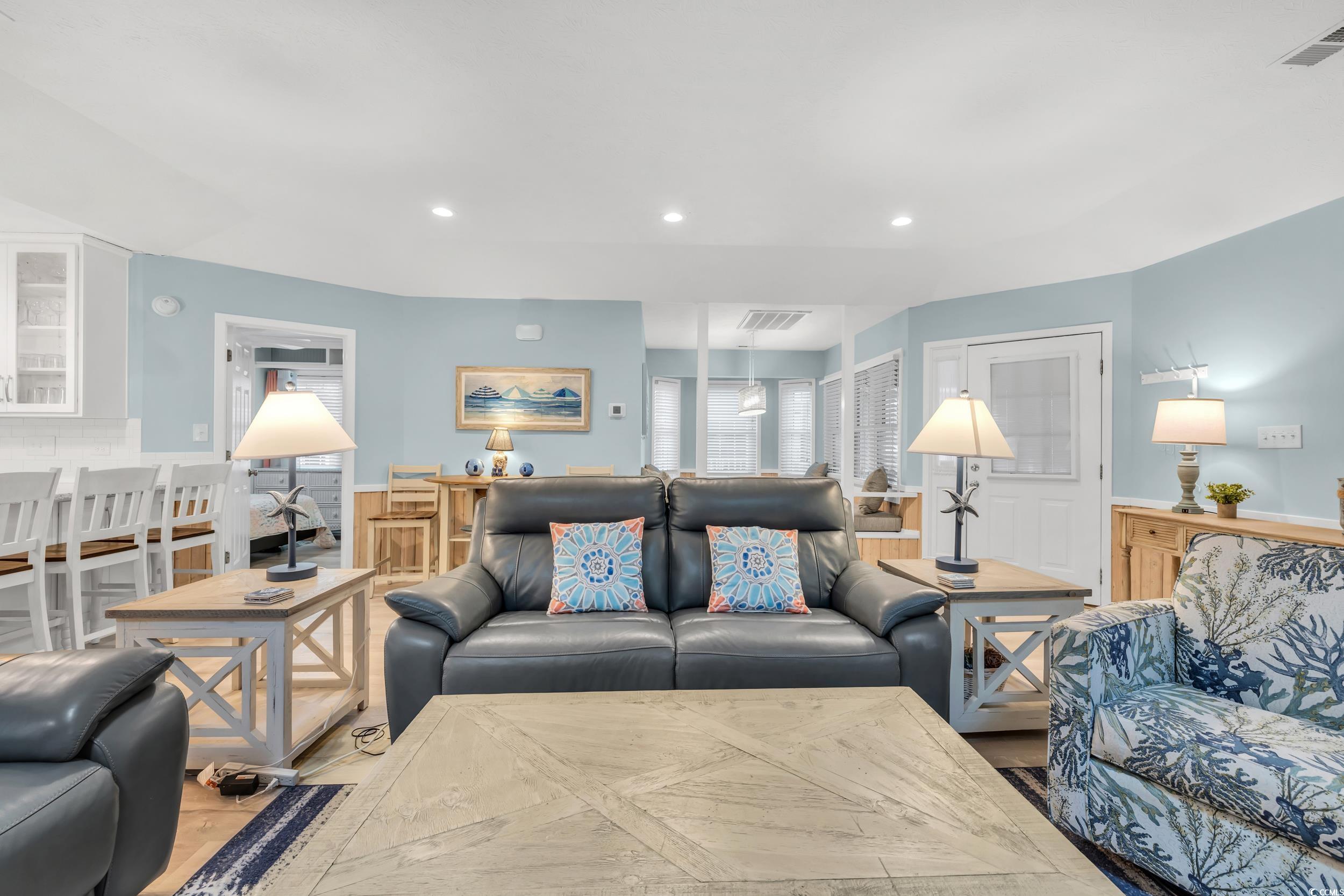 Living room with light hardwood / wood-style floors
