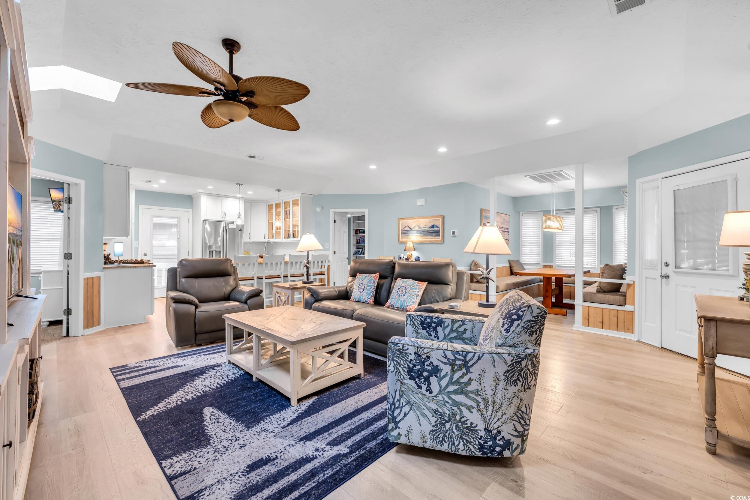 Living room featuring light hardwood / wood-style floors and ceiling fan