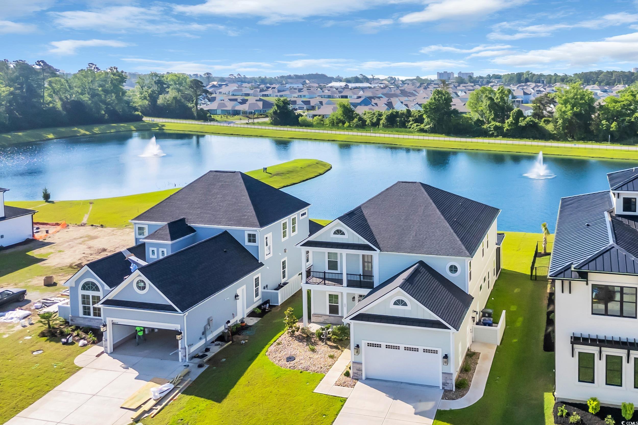 Aerial view of residential area featuring a nearby body of water