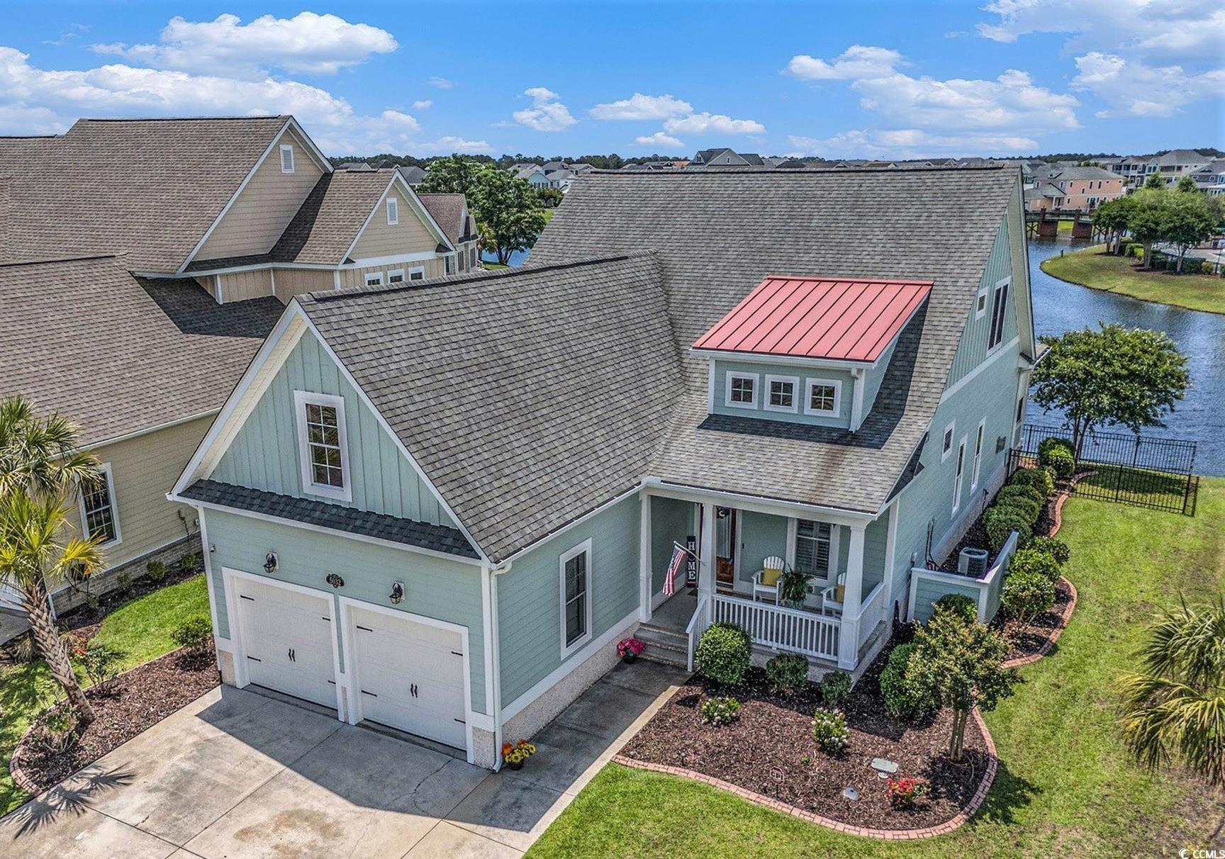 Gorgeous water views! Exquisite, high-end finishes! Upgrades galore! This immaculate home truly has it all! Gently nestled on a private waterfront lot within the prestigious, gated Waterway Palms Plantation community, this custom-built Low Country Charleston like home residence is a masterful blend of timeless elegance, modern comfort, and coastal convenience. From the moment you arrive, the home exudes Southern charm, with its sweeping porches and stately presence. Inside, a thoughtfully designed open-concept floor plan unfolds across two spacious stories, offering four bedrooms, three and a half bathrooms, and a large, partially-finished attic space rich with opportunity! Crafted with attention to detail and sophisticated style, the main level features a grand living room full of natural light from floor-to-ceiling windows accented by the comforts of the gas fireplace. At the heart of the home lies a chef’s dream kitchen, equipped with a professional 6-burner Blue Star gas range with pot filler, premium Kitchenaid refrigerator, dishwasher and microwave,  a custom oversized pantry, farmhouse sink, and an expansive island. Custom cabinetry, gleaming quartz countertops and a chic glass tile backsplash create the ultimate culinary experience. The first-floor primary suite feels like a private retreat; coffered ceilings, a custom walk-in closet, and a spa-like bathroom with luxurious finishes create a serene atmosphere perfect for unwinding. An additional bedroom on the main level is perfect for guests or to act as an office or study. Upstairs, two additional bedrooms each enjoy their own ensuite baths, while a versatile flex room opens through sliding doors out to a covered porch overlooking the tranquil pond. A generous attic space has been partially finished, offering exciting potential for a future bonus room or studio.  Outside, entertaining is a breeze within the serene screened rear porch that comes complete with a high-end outdoor kitchen with a gourmet Coyote grill and refrigerator. Residents of Waterway Palms enjoy world-class amenities, including a resort-style pool, elegant clubhouse, tennis courts, playground, boat storage, and private community boat ramp providing access to the Intracoastal Waterway. Don’t miss your opportunity to experience this exquisite coastal haven—schedule your private tour today.