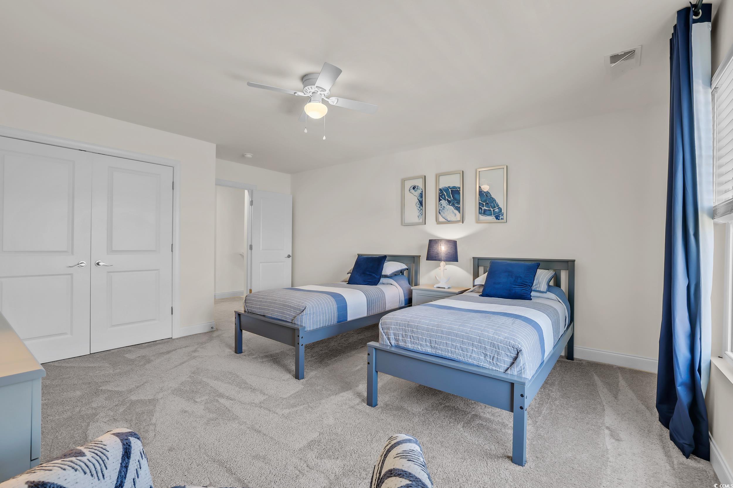 Bedroom with carpet flooring, baseboards, ceiling fan, and a closet