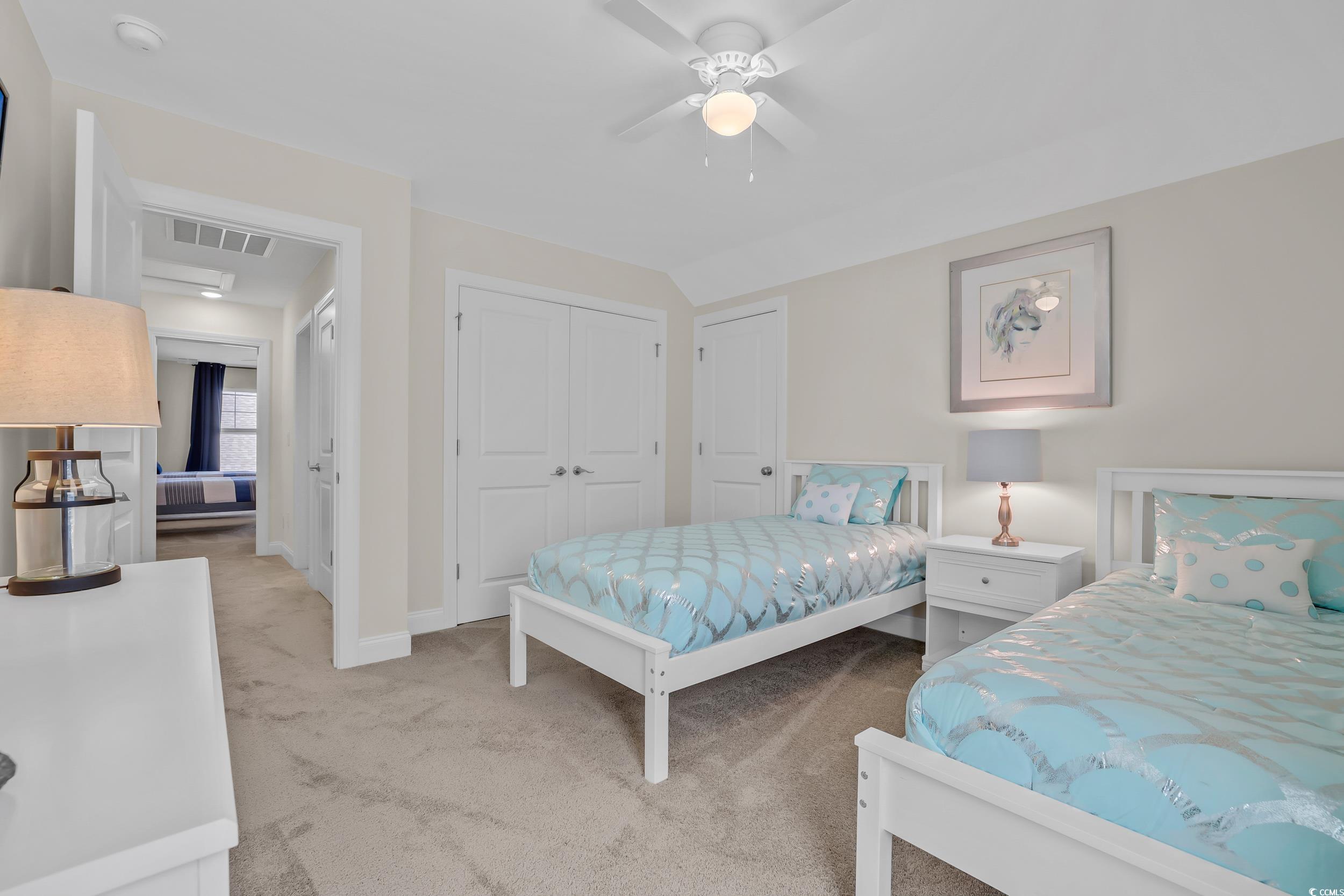Bedroom with light carpet, baseboards, a closet, and ceiling fan